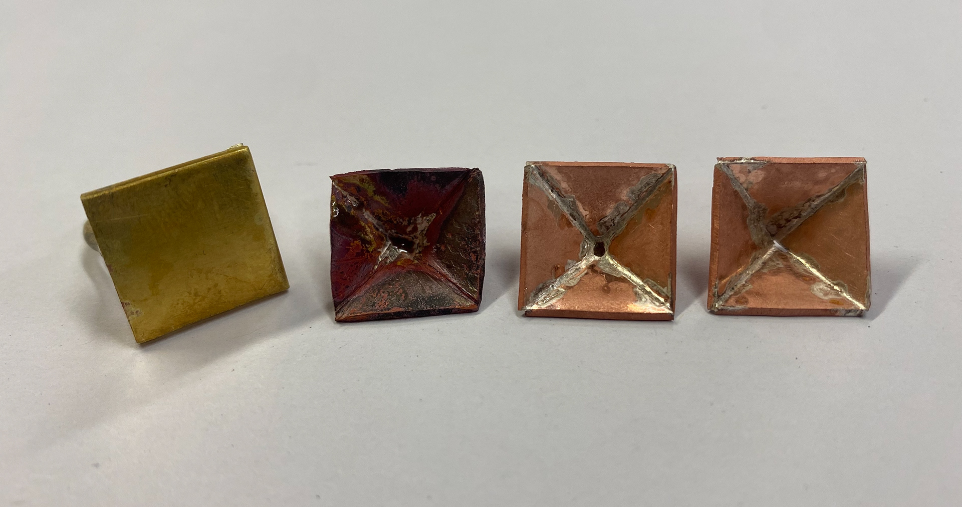 The underneath of each test piece. Left, soldered from net shape. Middle, second attempt of original method. Right first attempt.
