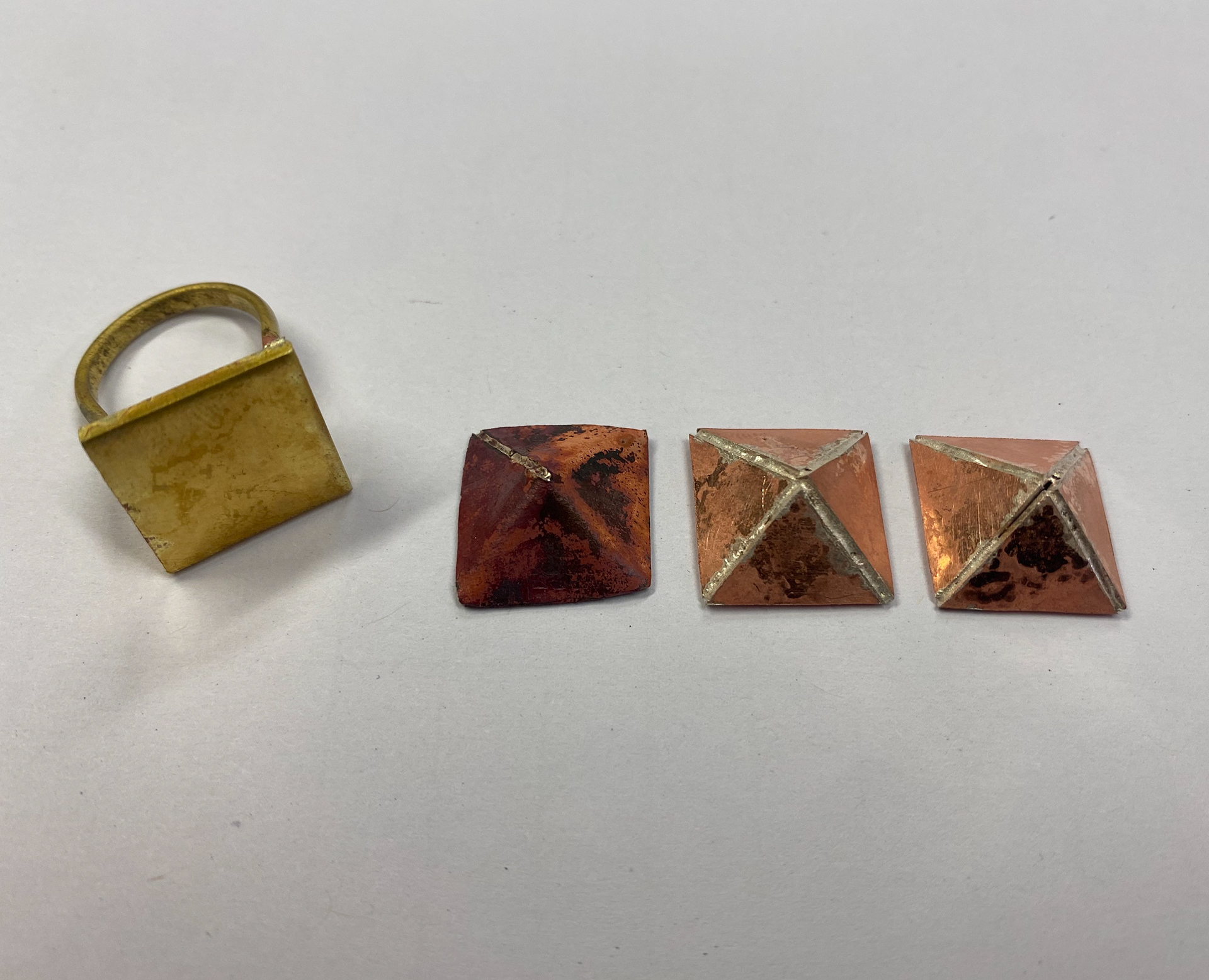 The tops of each test piece. Left, soldered from net shape. Middle, second attempt of original method. Right first attempt.