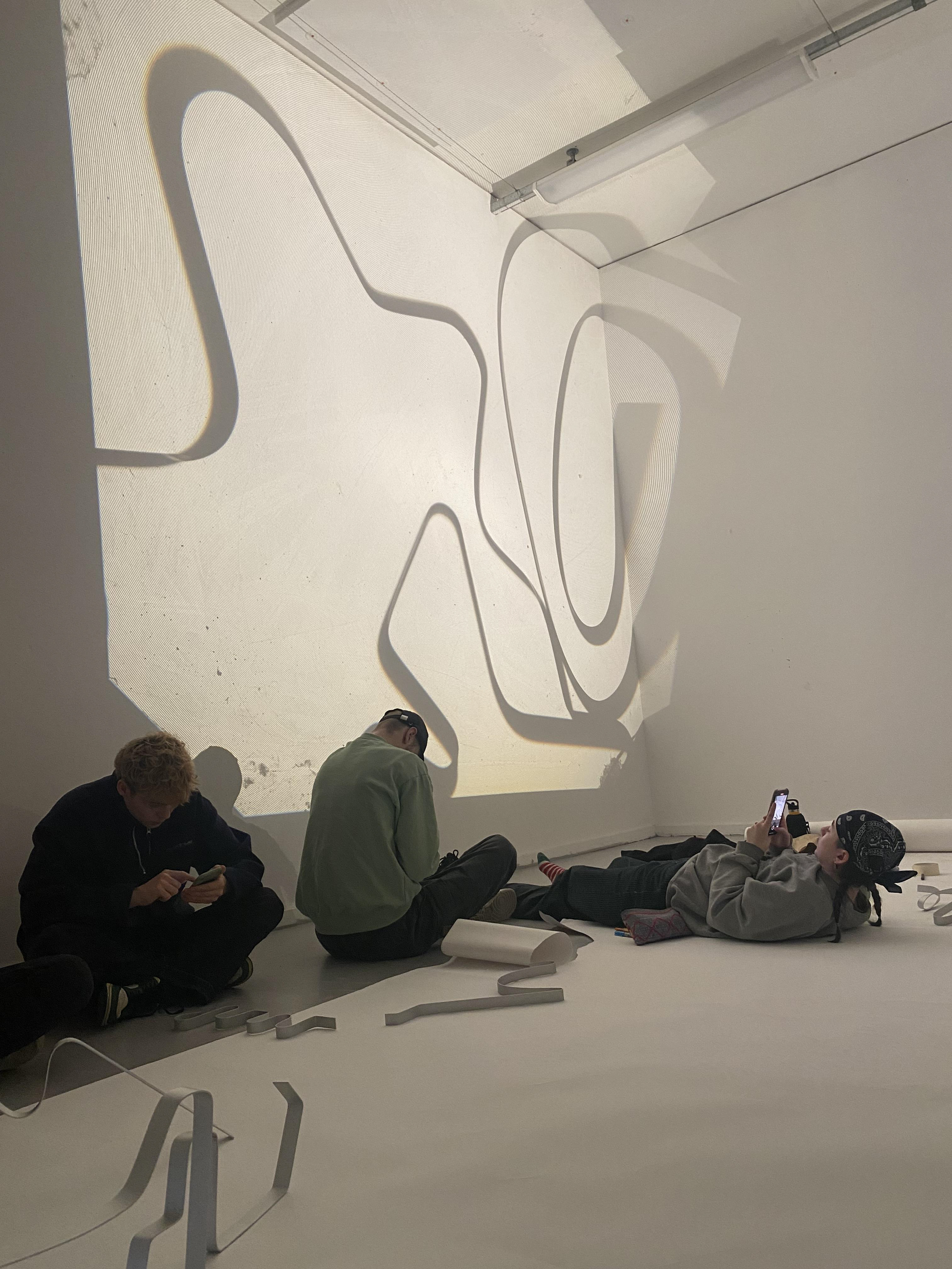 Using the light box to project bigger shadows as a group onto the walls of the studio