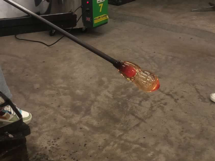 Early stages of blowing a bubble in molten glass.
