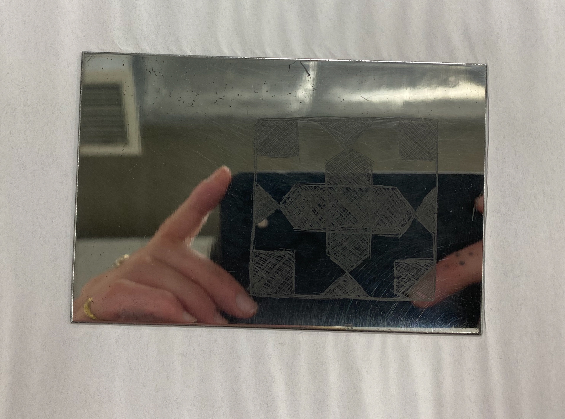 Ink applied to the metal and the excess removed