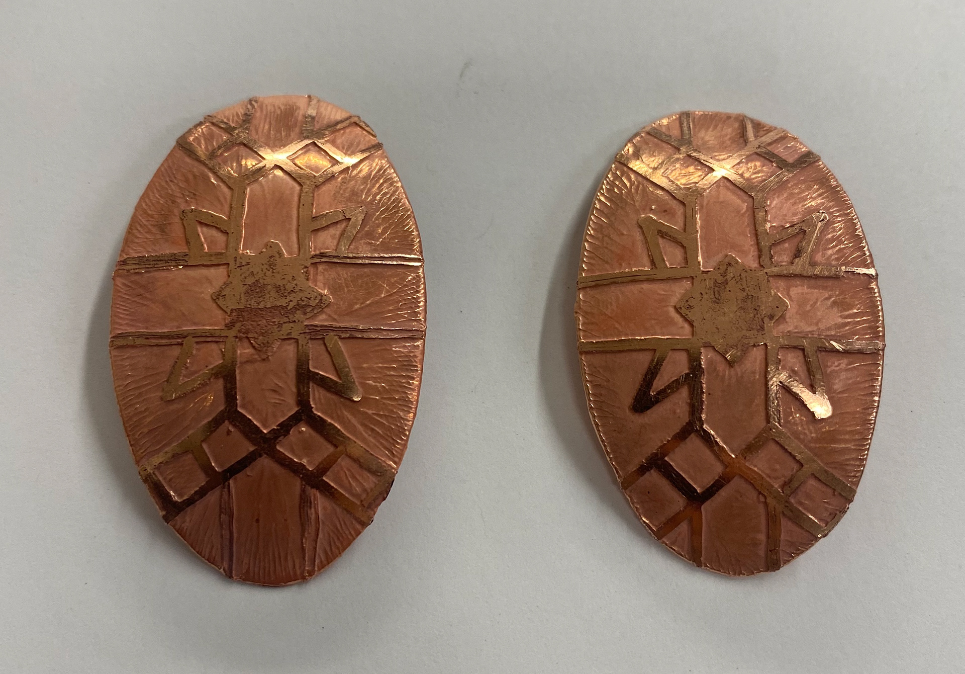 Both pieces after being etched and domed