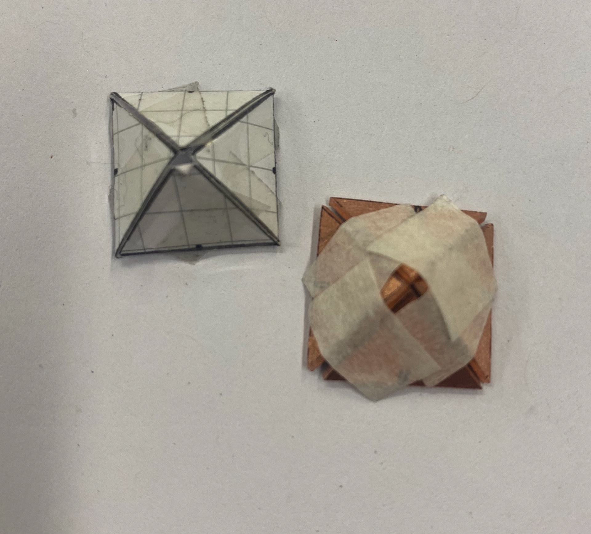 Paper model and first metal attempt joined together using masking tape