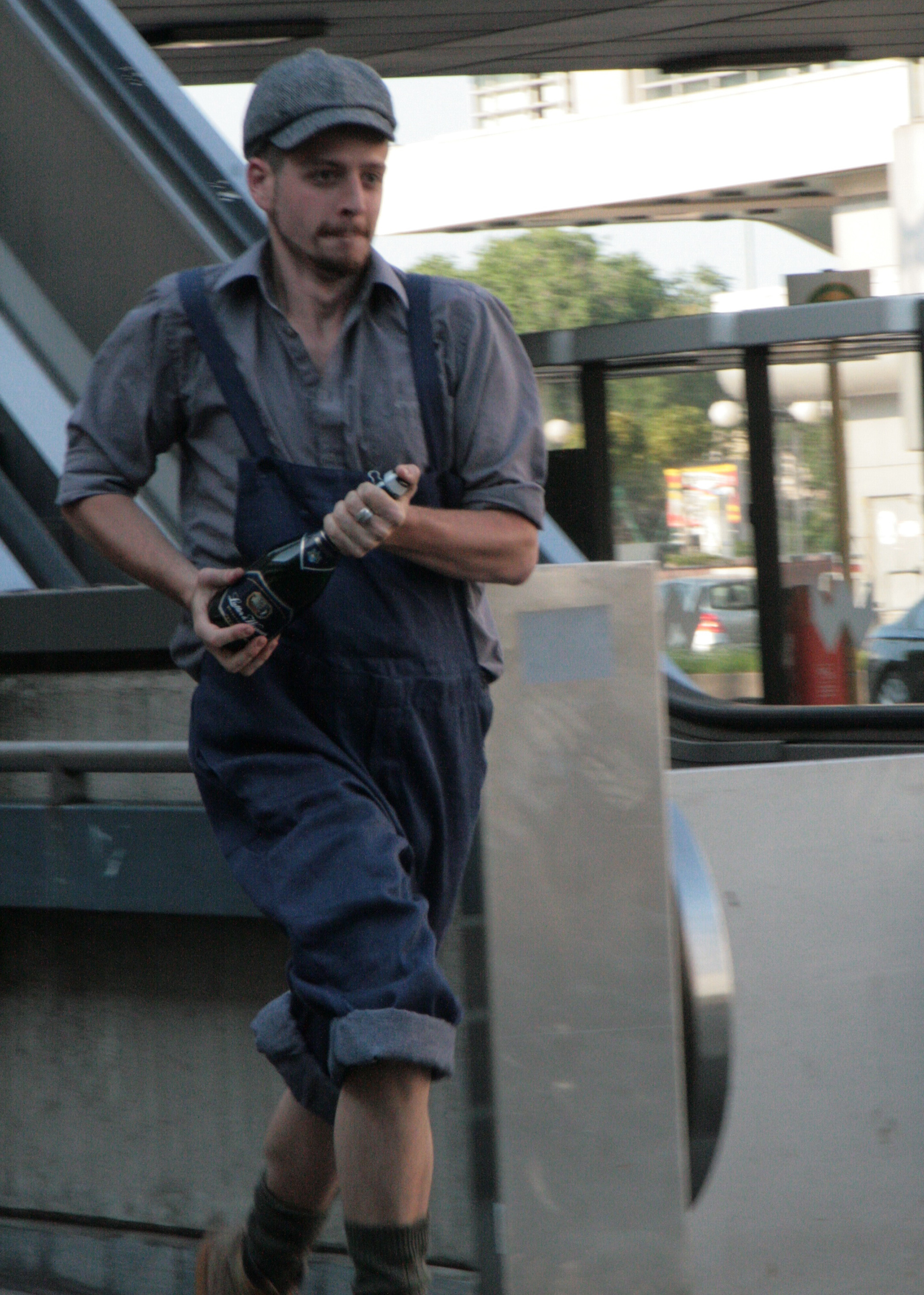 Still from the film "Victory", by Meyrick Kaminski. Running at ICC Messe Nord with a bottle of champagne.