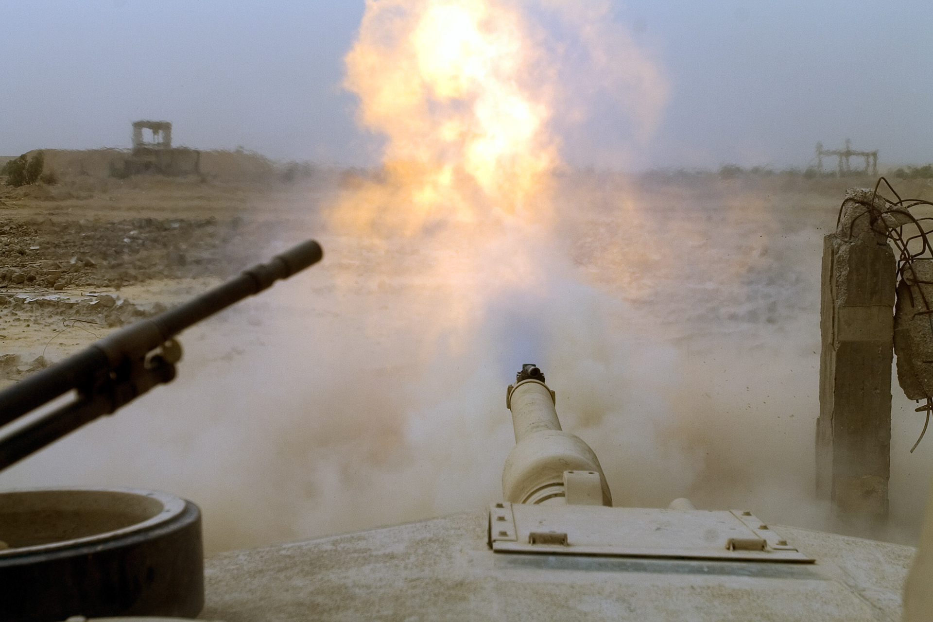 Target practice aimed at a former Republican Guard headquarters, as seen from the top of this M1 Abrams tank firing the round.