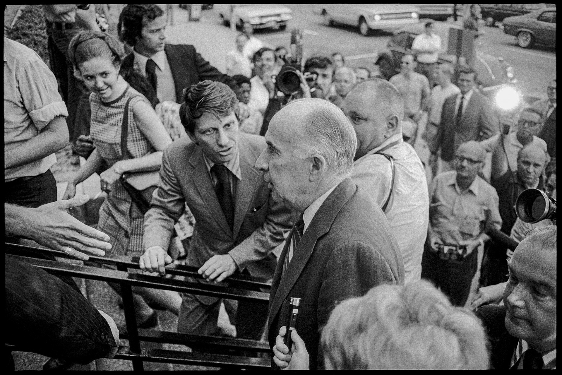 Former Attorney General John Mitchell entering the United States District Courthouse in Pensacola, Florida. He was to testify as a defense witness in a pretrial hearing for eight antiwar activists. 1973