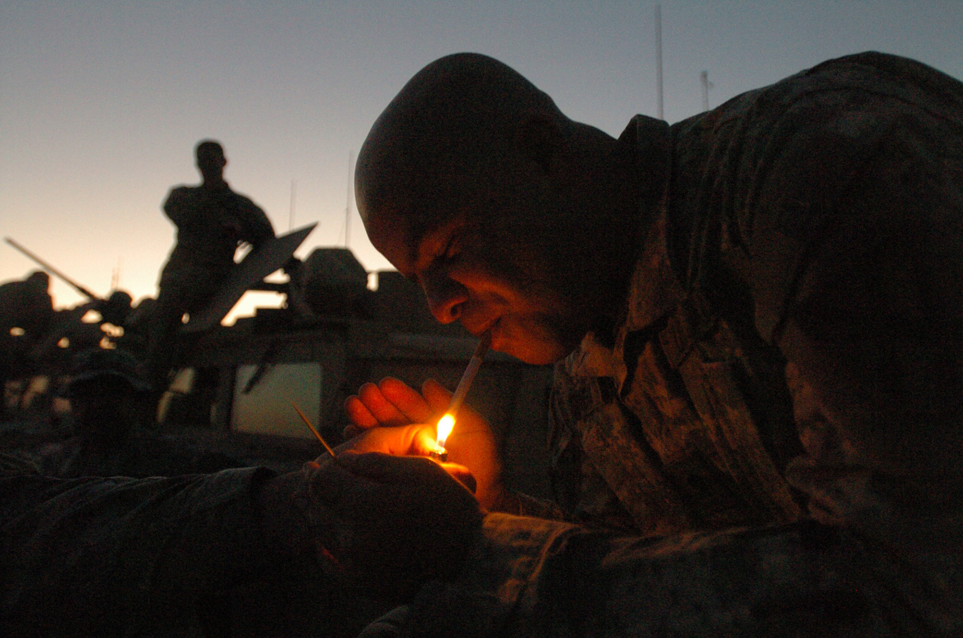 An American soldier having an after dinner cigarette before leaving on a 12 hour overnight patrol mission.