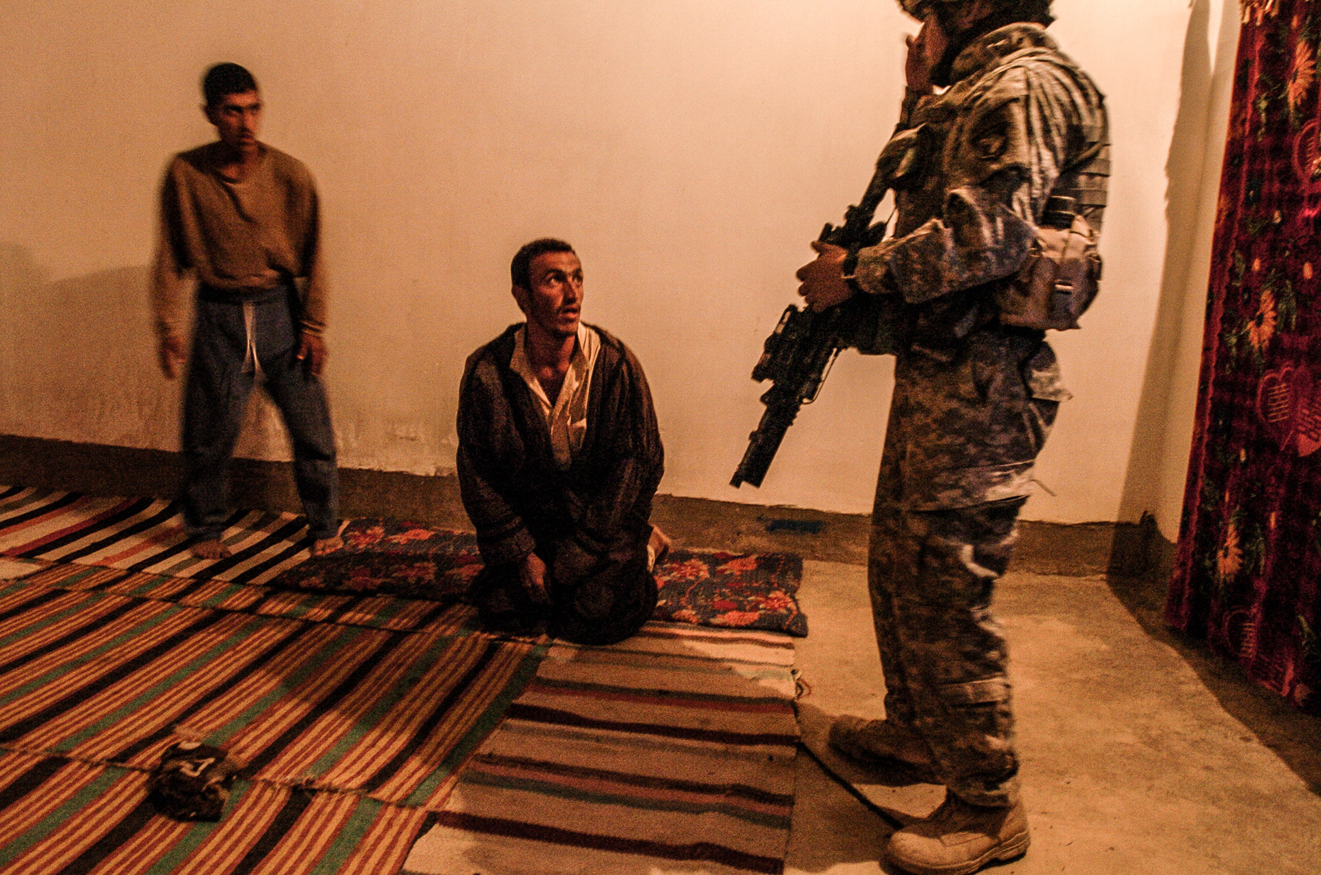 American soldiers questioning local Iraqis while on a night patrol in Lutayfiyah, south of Baghdad.