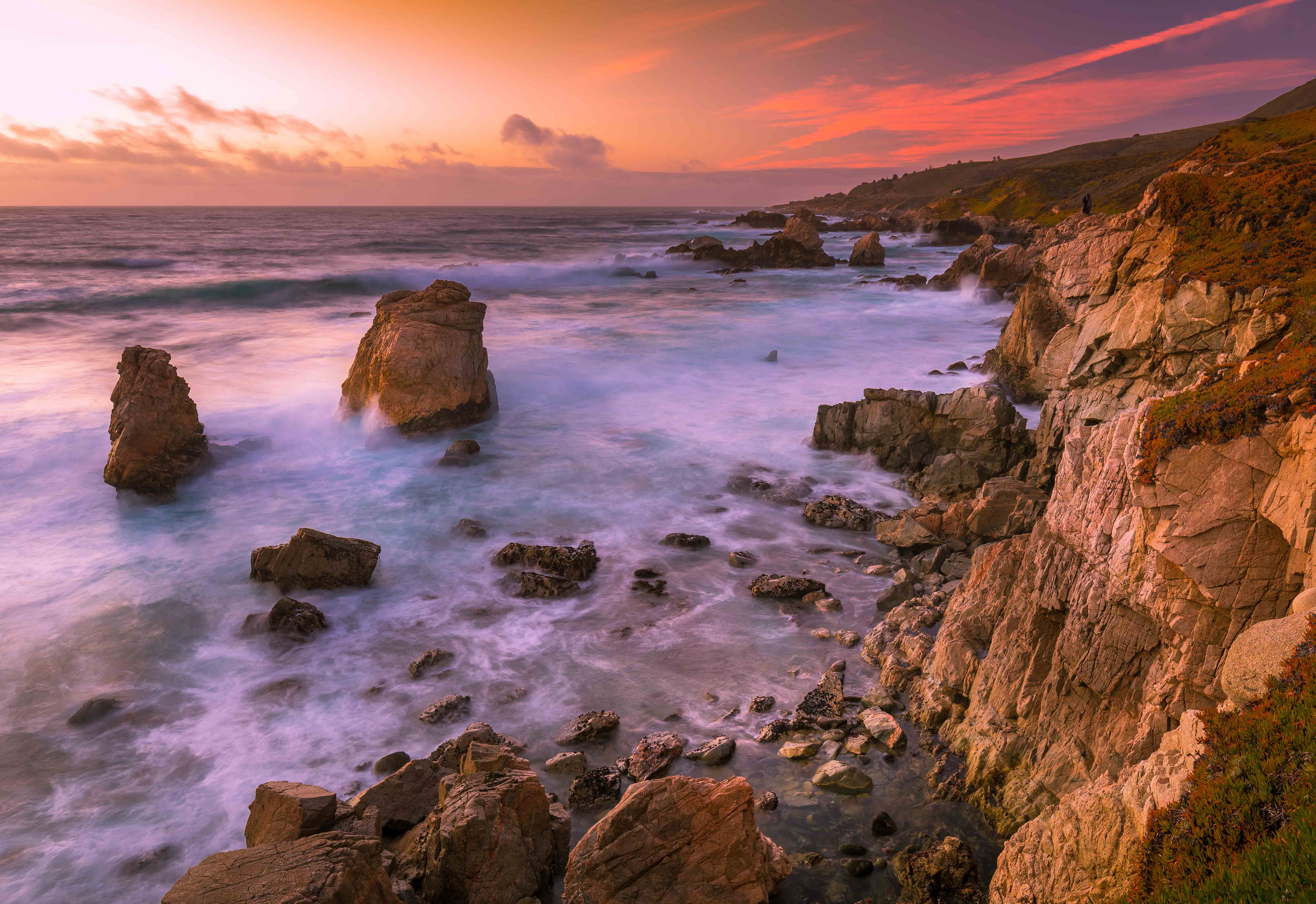 Seascape photography of sunset shining golden light on the California Coast in Big Sur