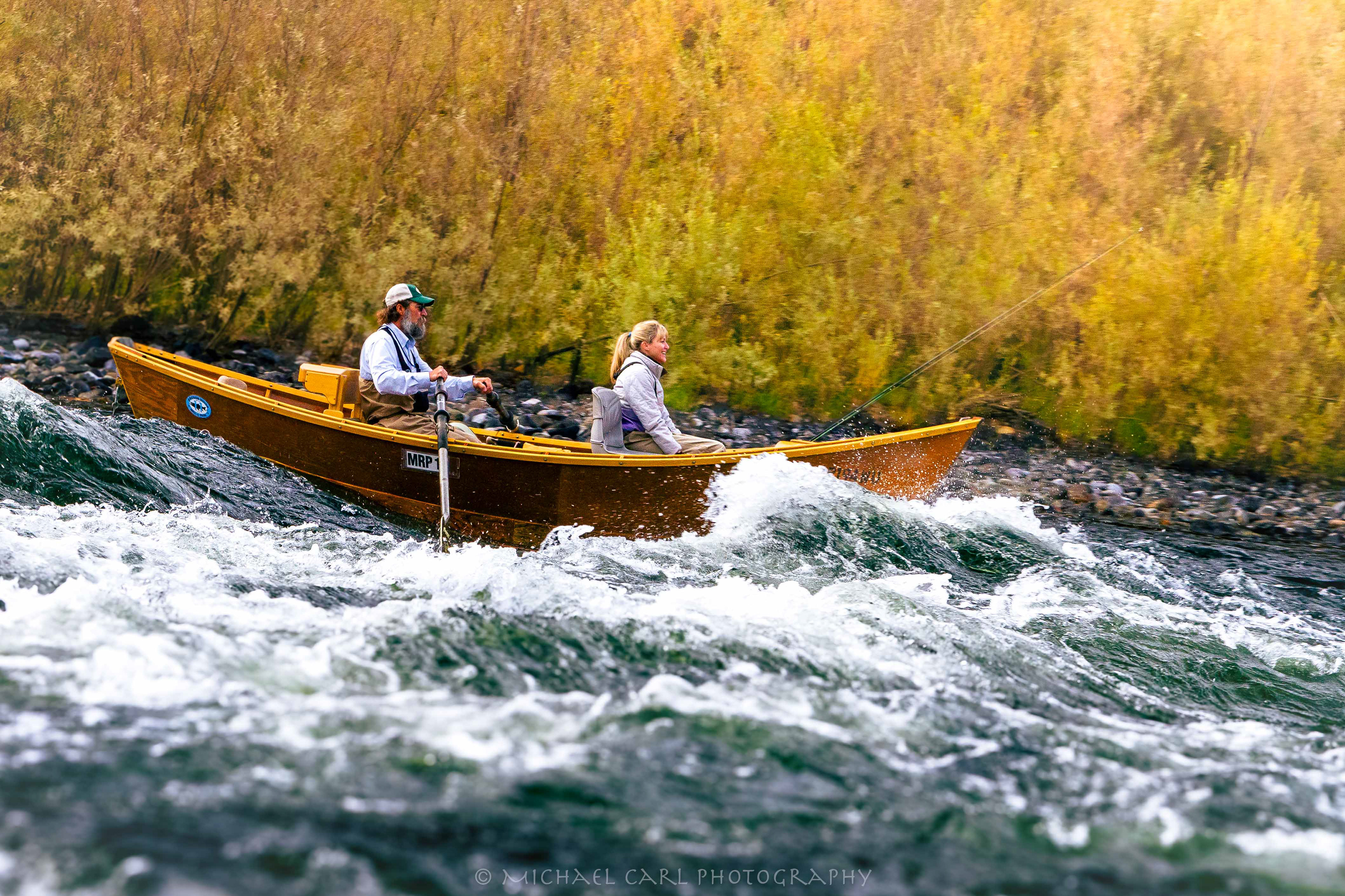 Fly fishing photography of wooden drift boat running whitewater on the Rogue River in Oregon