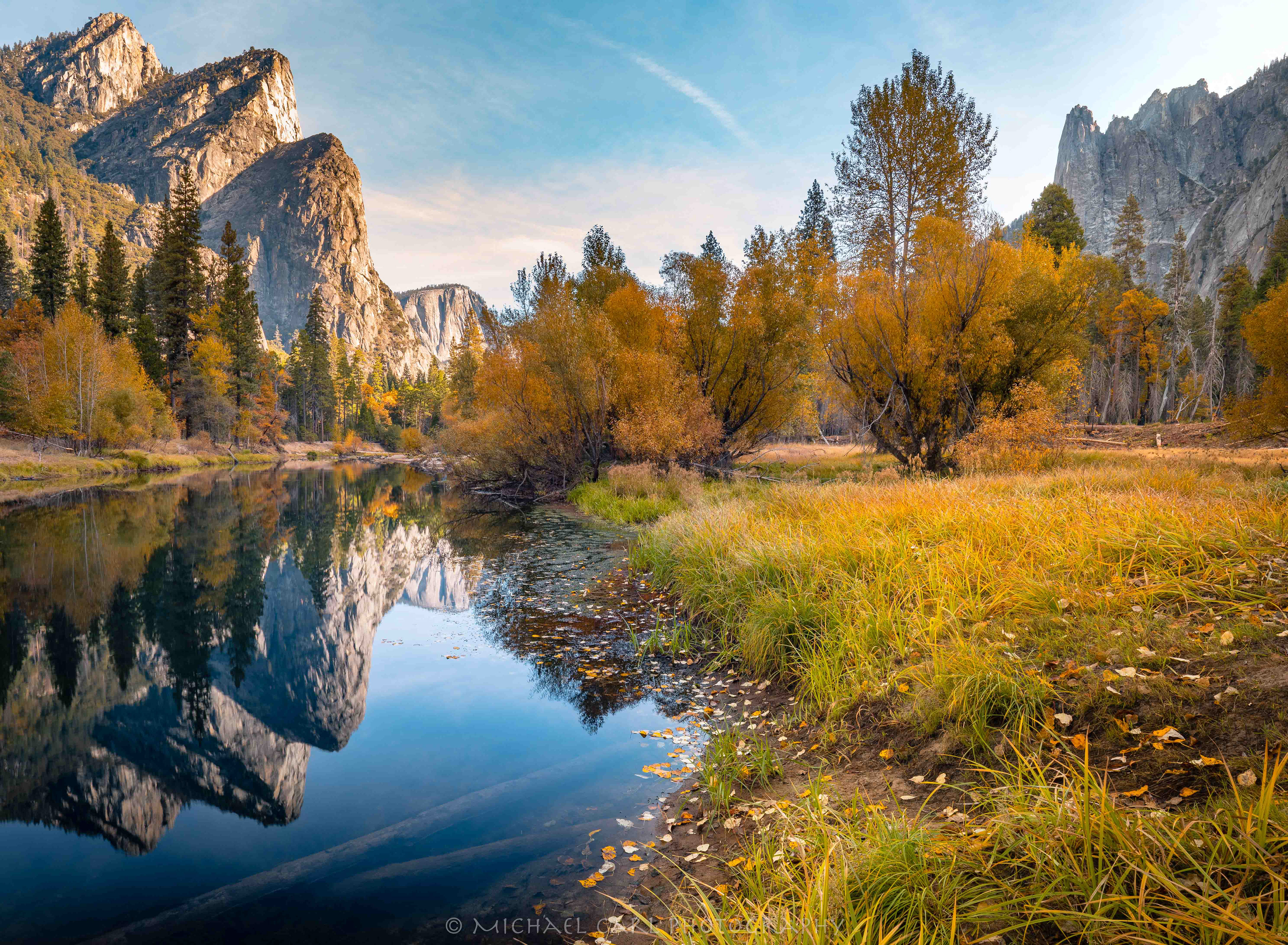 Yosemite Valley as the Three Brothers reflect off the Merced River in the Sierra Nevada Mountains.