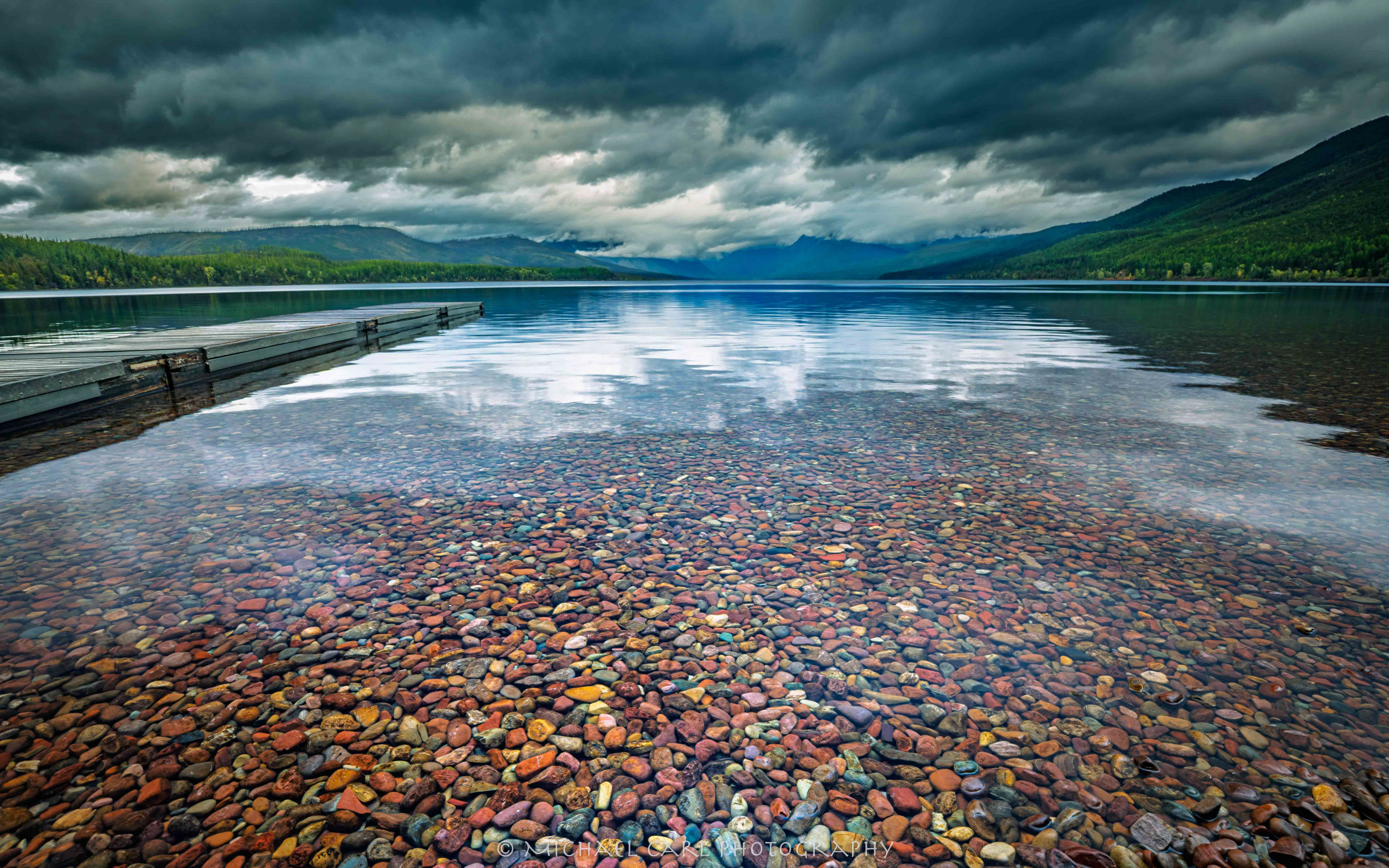 Glacier National Park photography of Lake McDonald reflection of storm clouds.