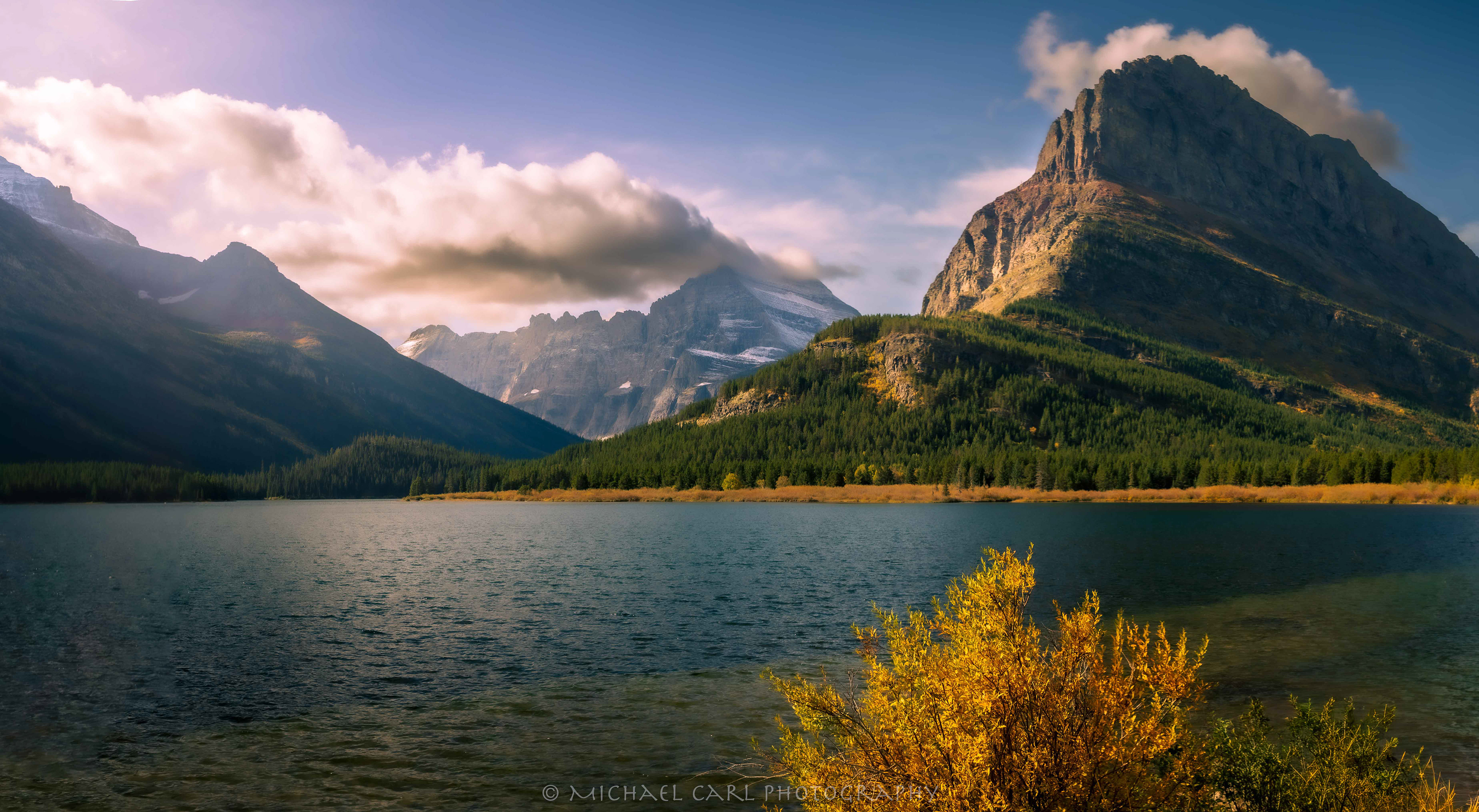 Many Glacier photography of sunrise on Grinnell Point from Swiftcurrent Lake Montana.