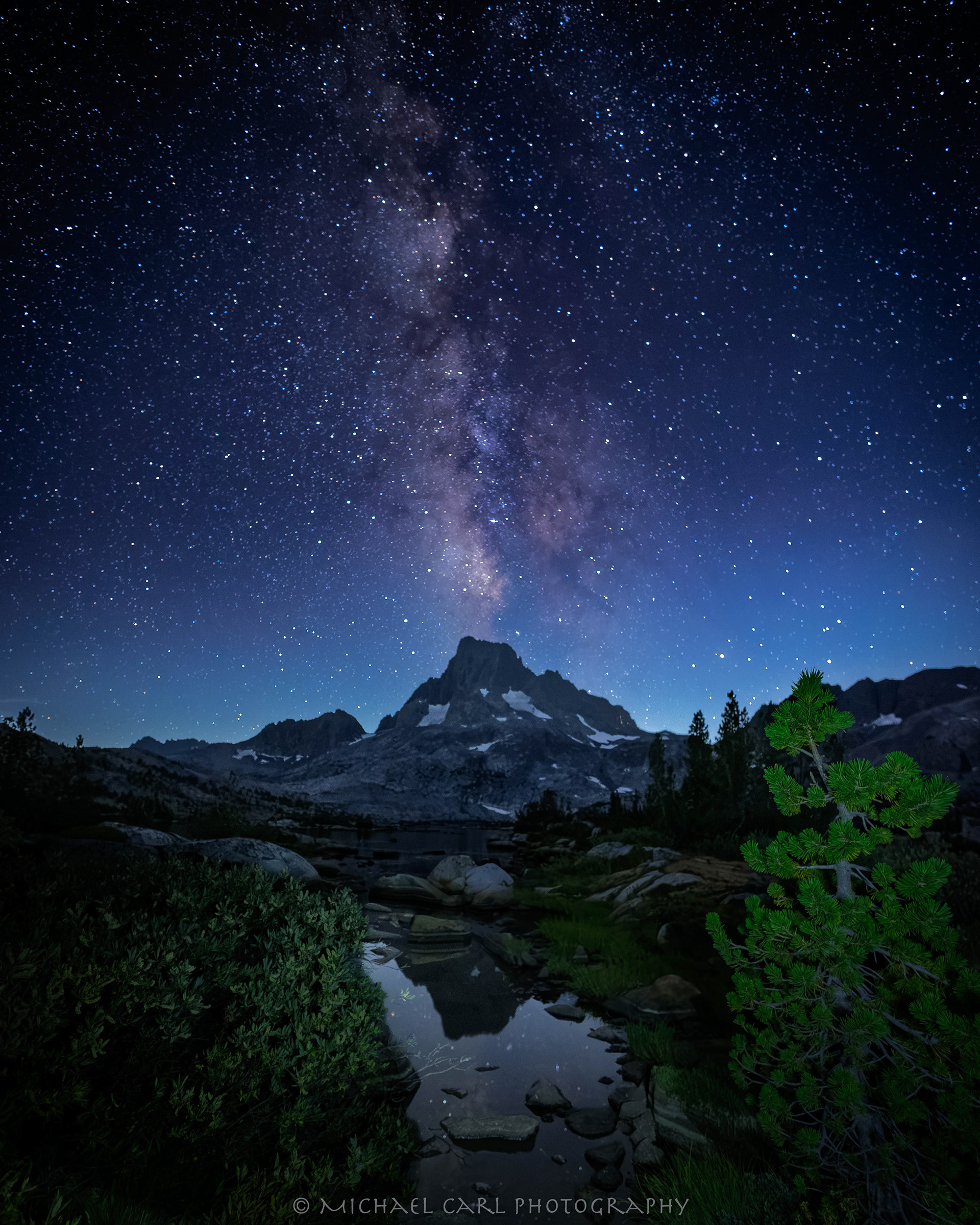 Sierra Nevada Mountains night sky photography of Banner Peak reflected on Thousand Island Lake.
