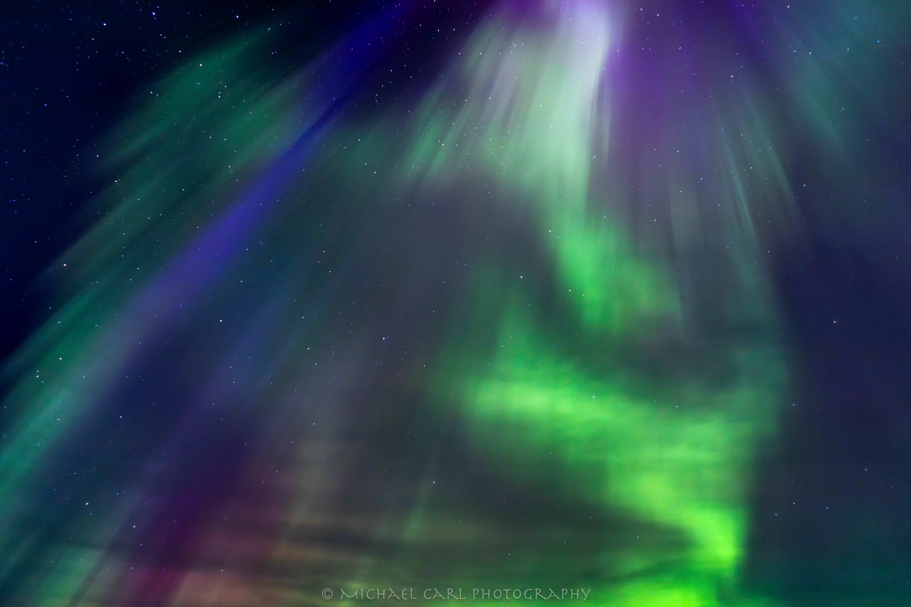 Night sky photography of the aurora borealis in Southern Iceland with a magnificent corona display overhead.
