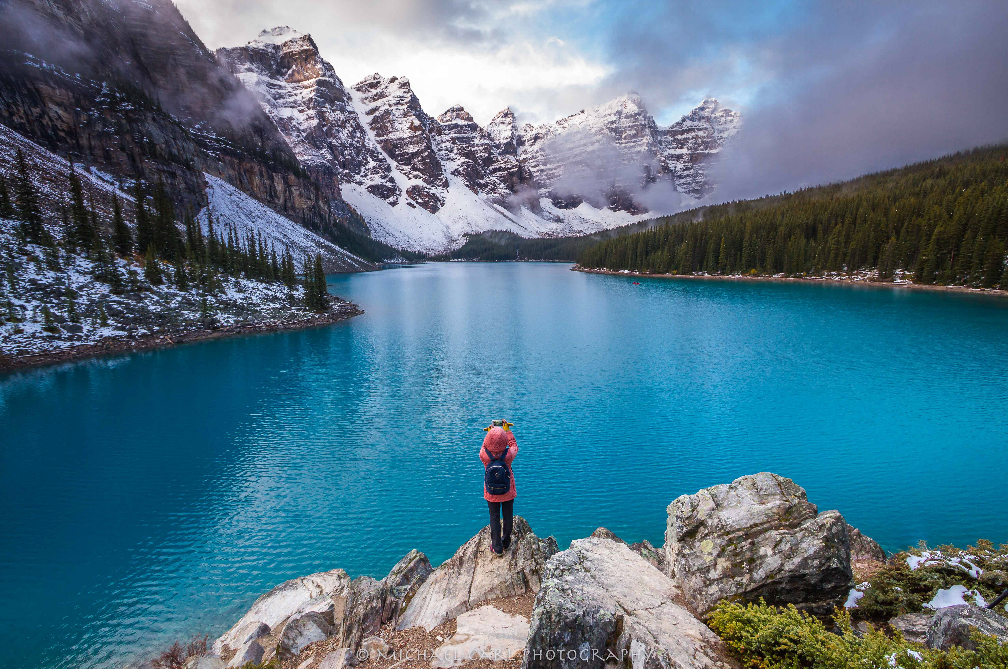 Outdoor adventure photography captures fleeting moments when storm clouds part over Moraine Lake in Banff National Park Canada