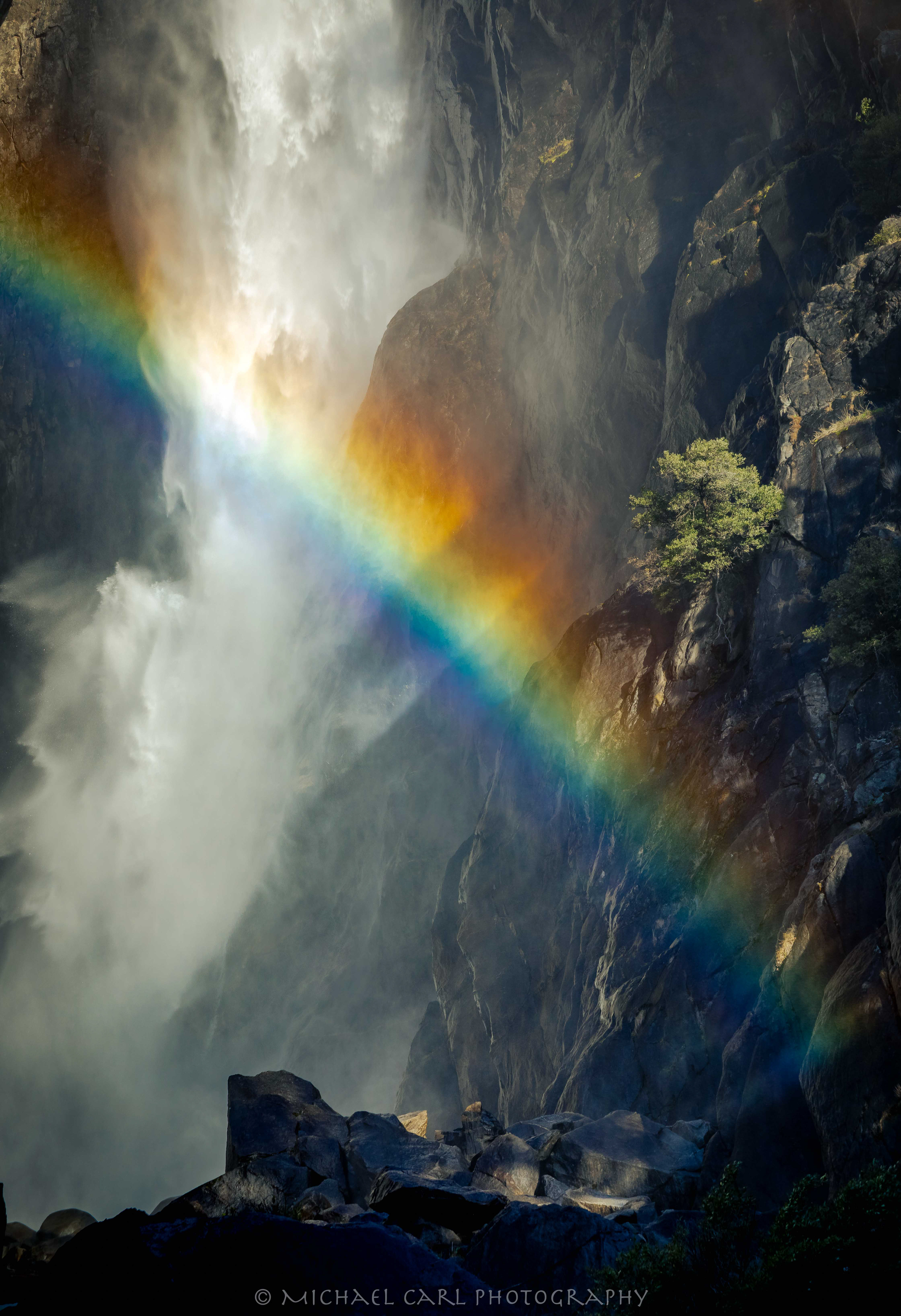 Waterfall photograph taken at Yosemite Falls as the sun lights up a rainbow in the mist