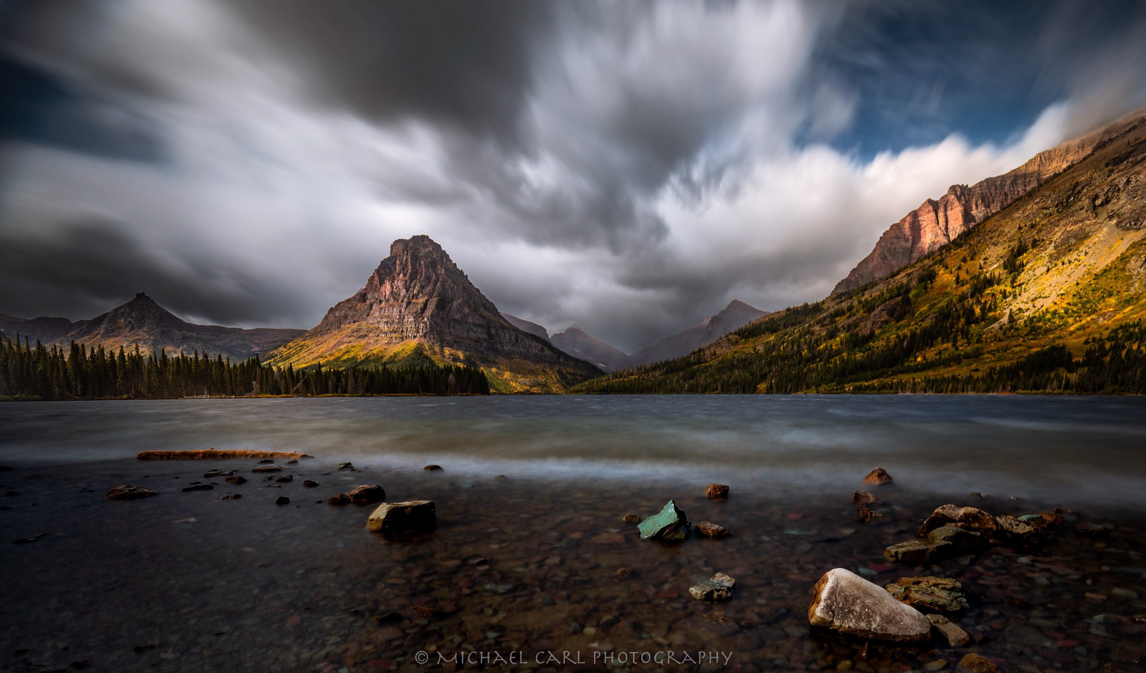 Two Medicine Lake Glacier National Park photography as storm rushes over Rocky Mountains.