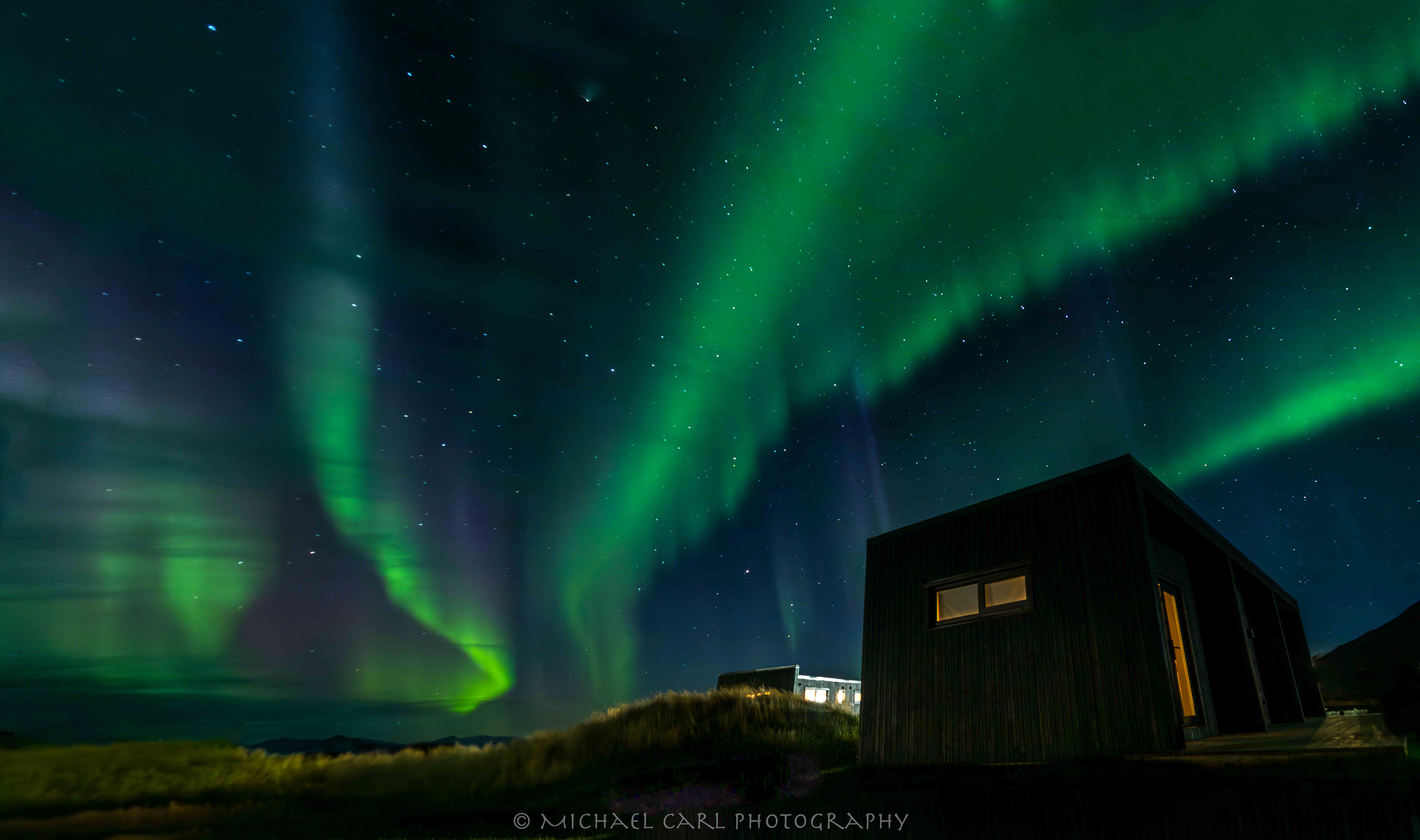 Night sky photography of Northern Lights display aurora borealis in Iceland by Michael Carl