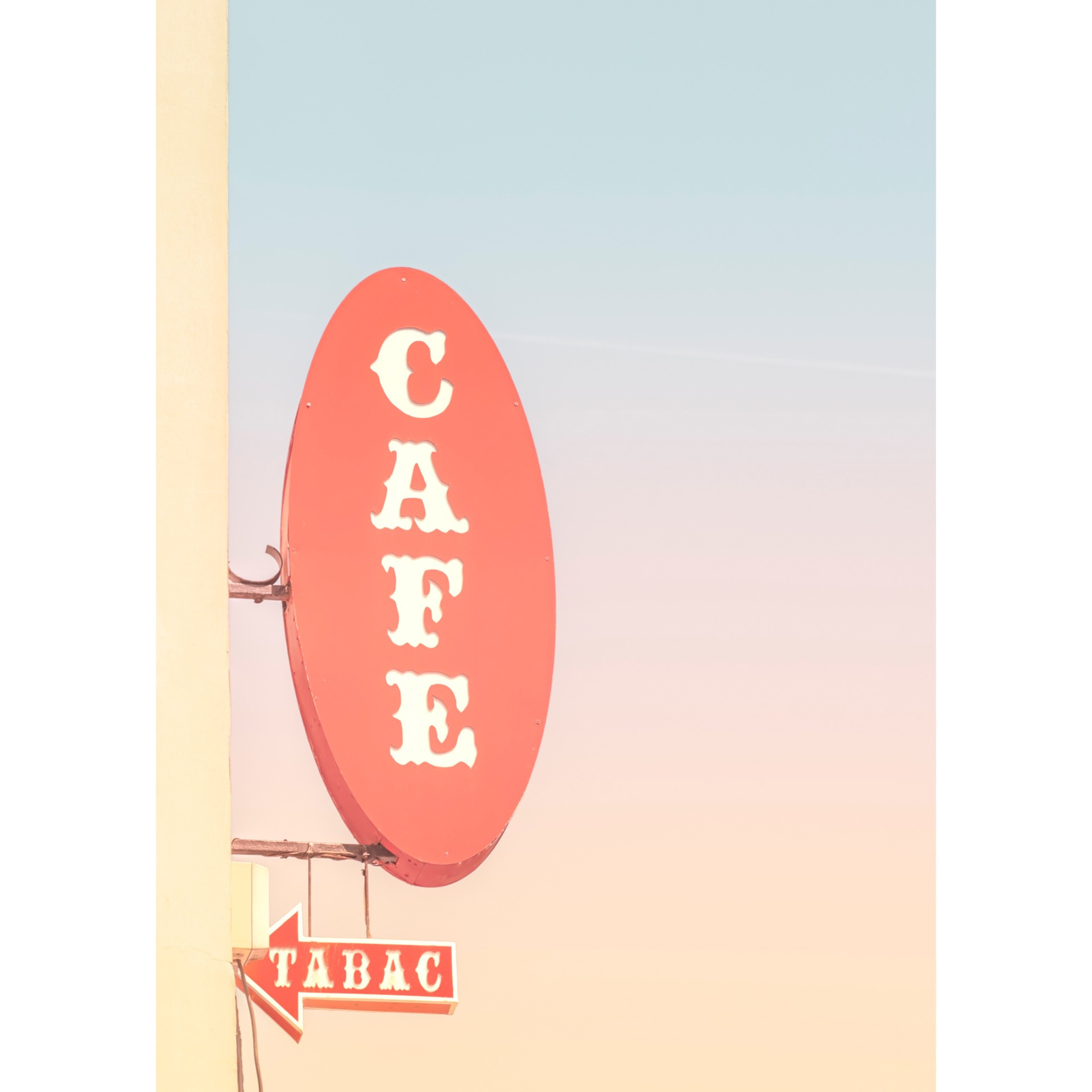 Detailed view of the Paris metro sign on a sunset pastel gradient sky. A minimalist and colorful photograph with a poetic and soothing look.