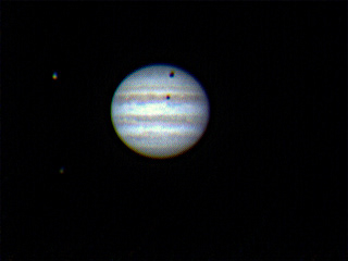 Jupiter with two of its moons and their shadows. Photo by Ed Ting.