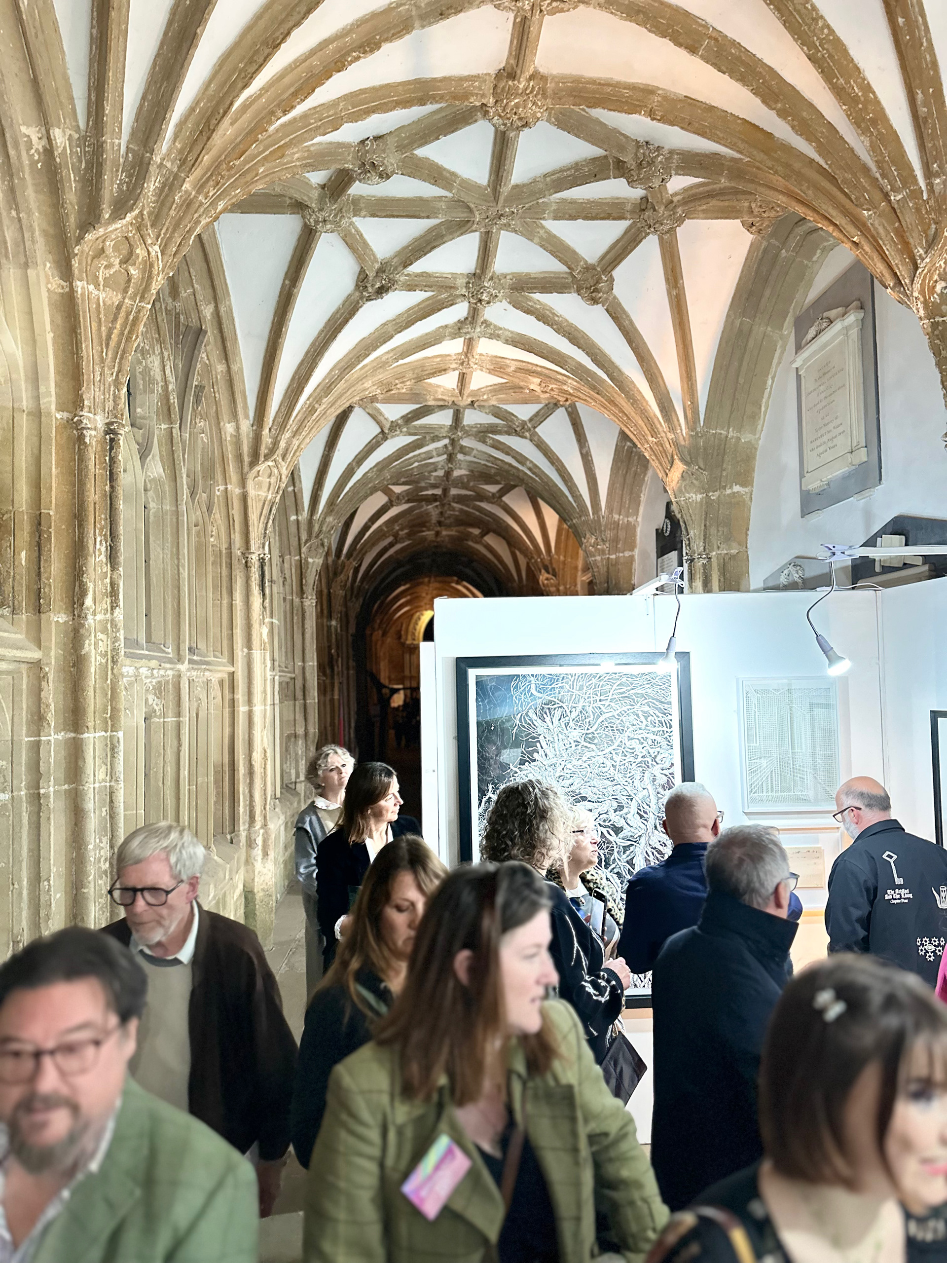 Private View at Wells Cathedral — visitors in the cloisters during Wells Art Contemporary 2025
