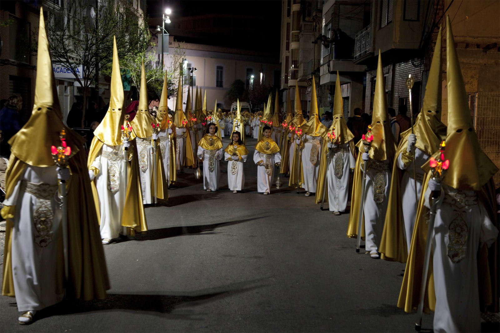 Nazarenos in a night time procession during Semana Santa (Holy Week) in Cartagena, Spain