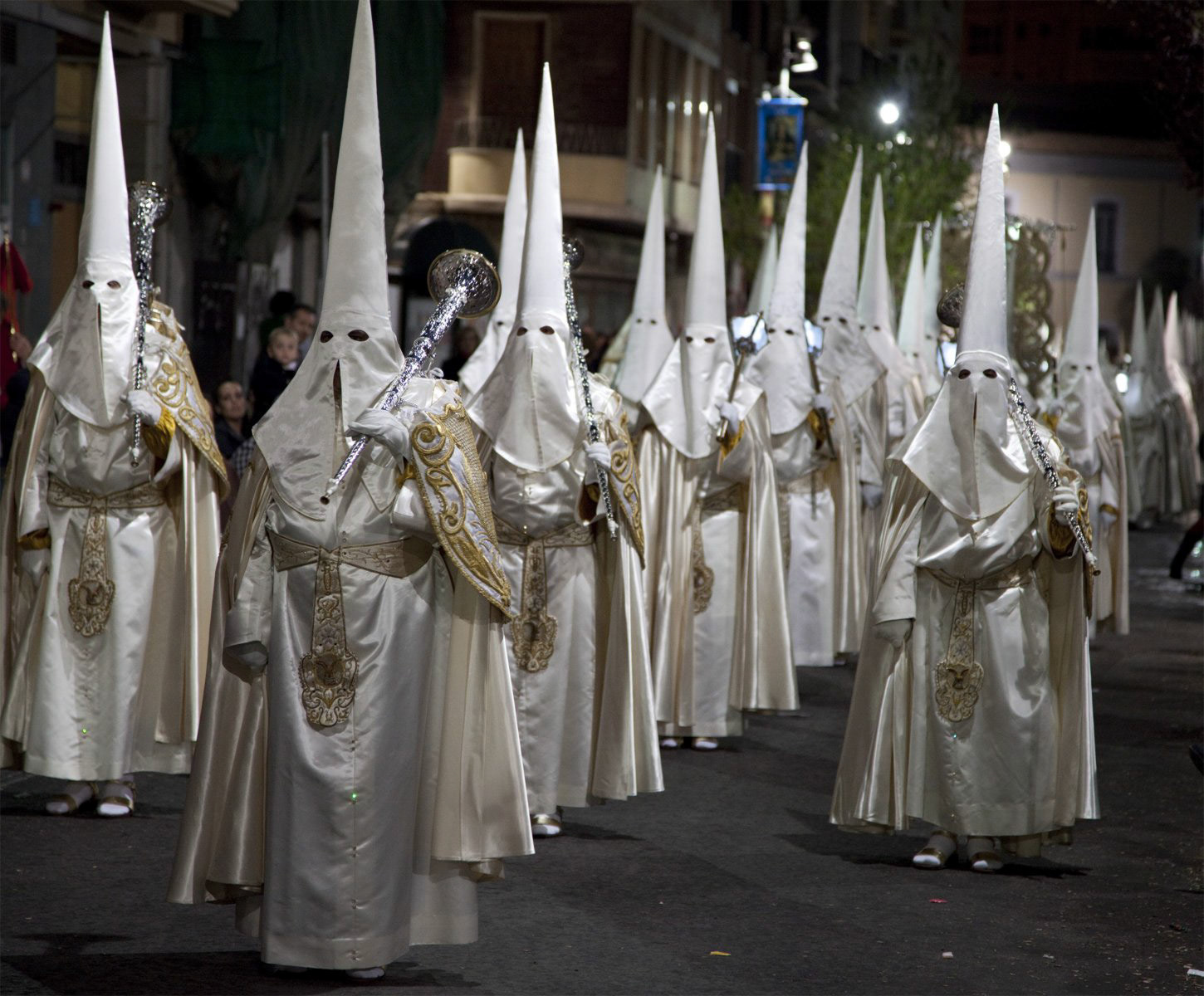 Nazarenos in a night time procession during Semana Santa (Holy Week) in Cartagena, Spain