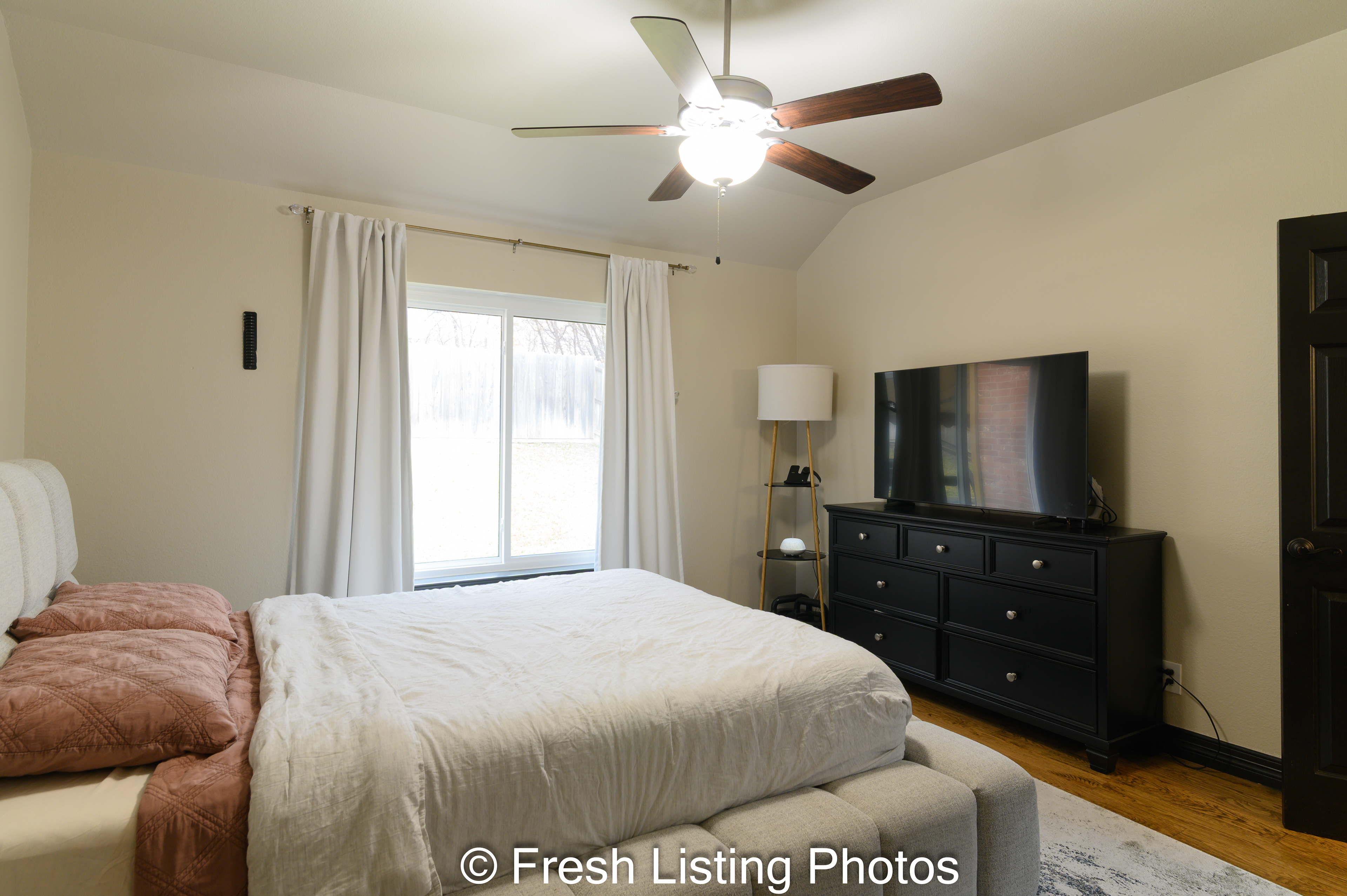 Primary bedroom with view of the backyard