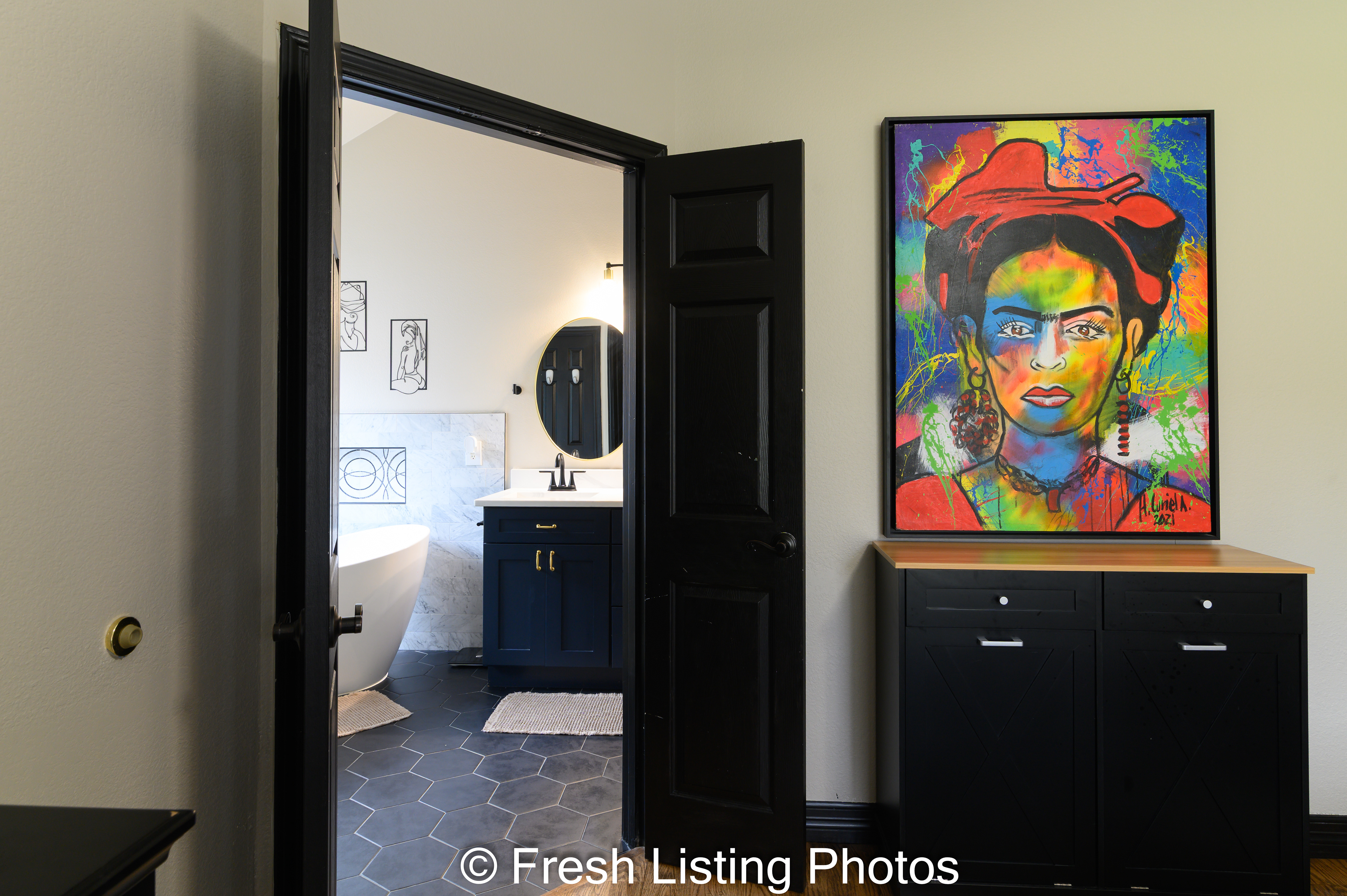 Primary bedroom with view of primary bathroom