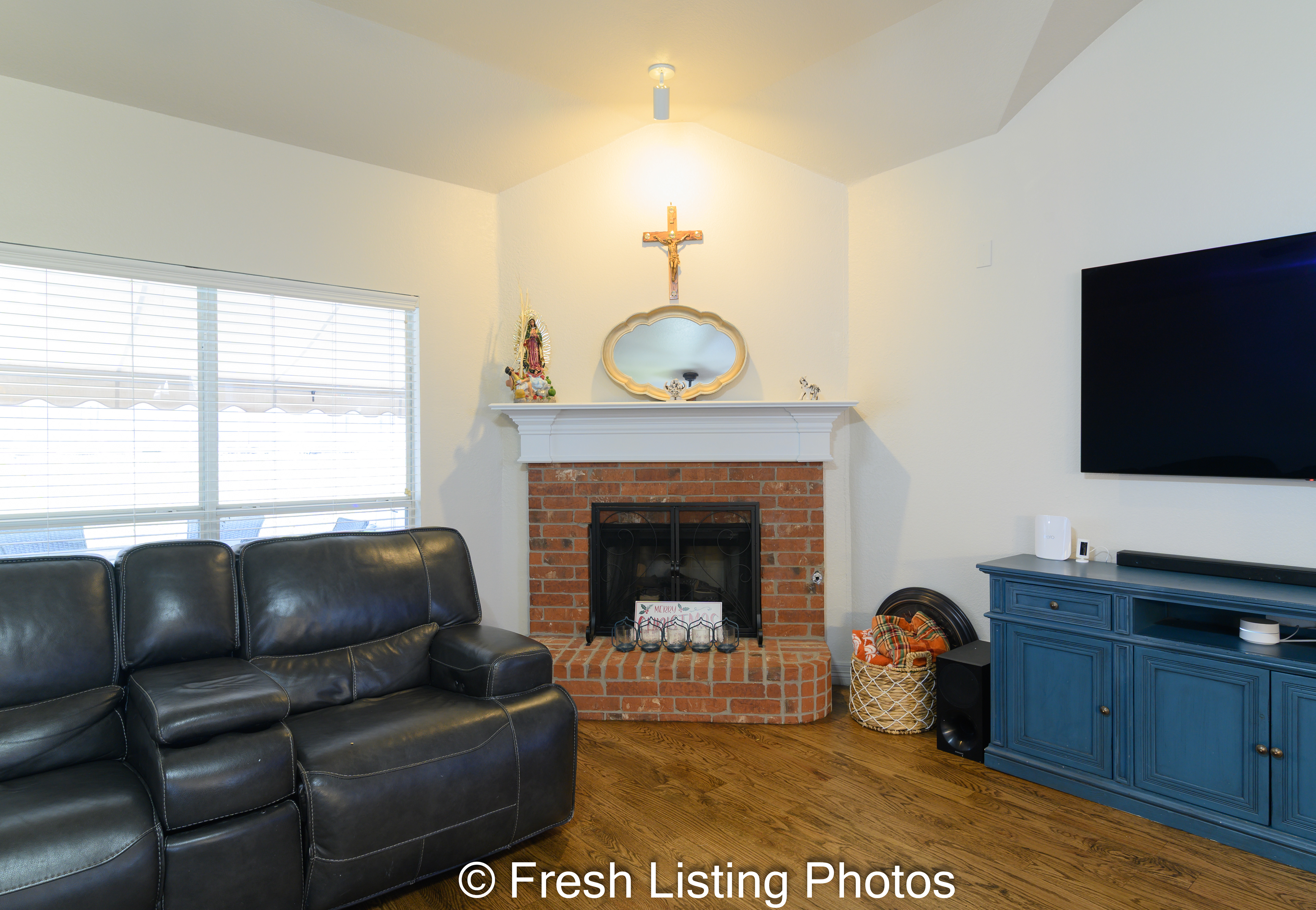 Living room with brick facade fireplace