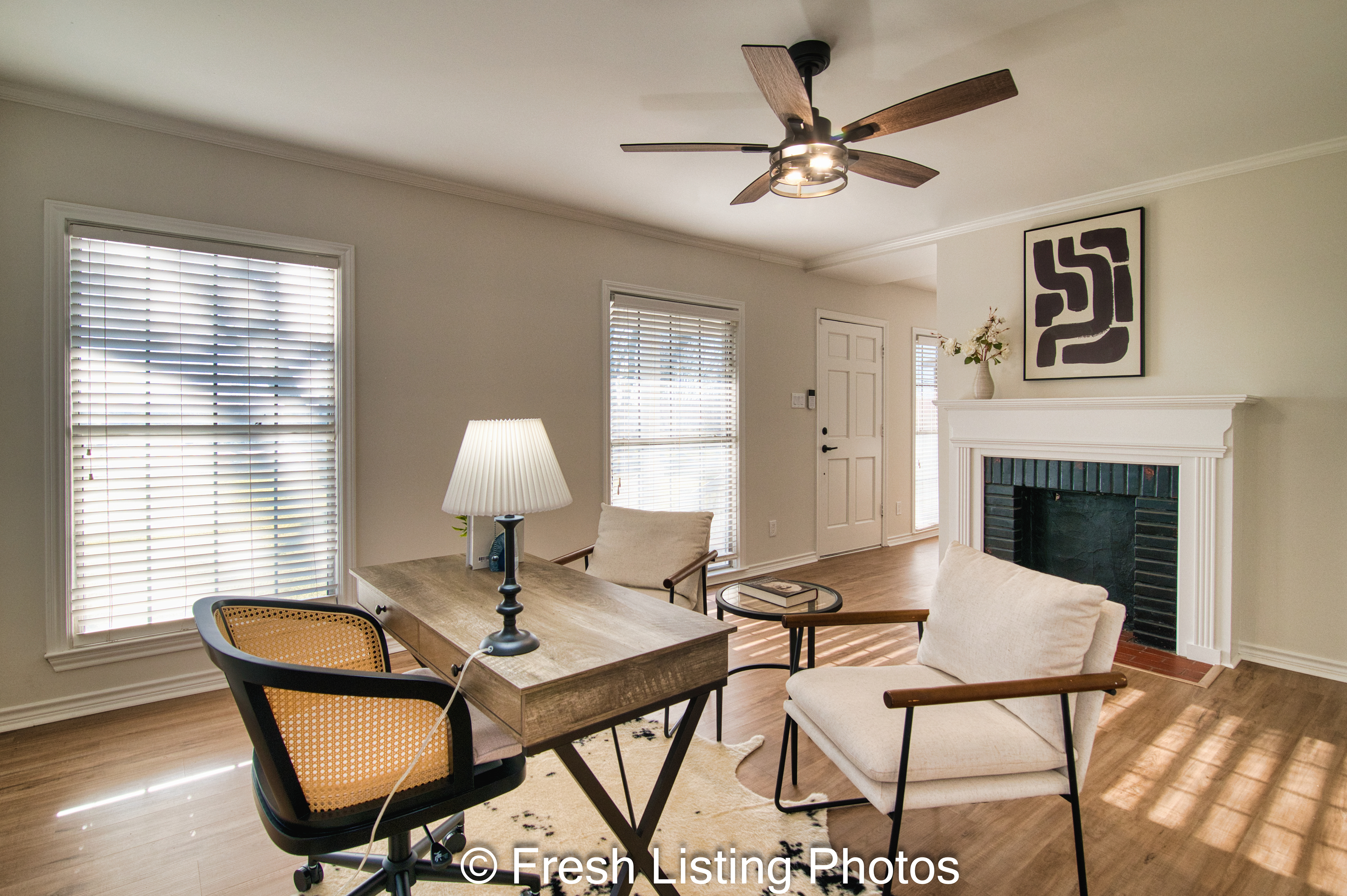 Furnished living room with dual-sided fireplace and front door