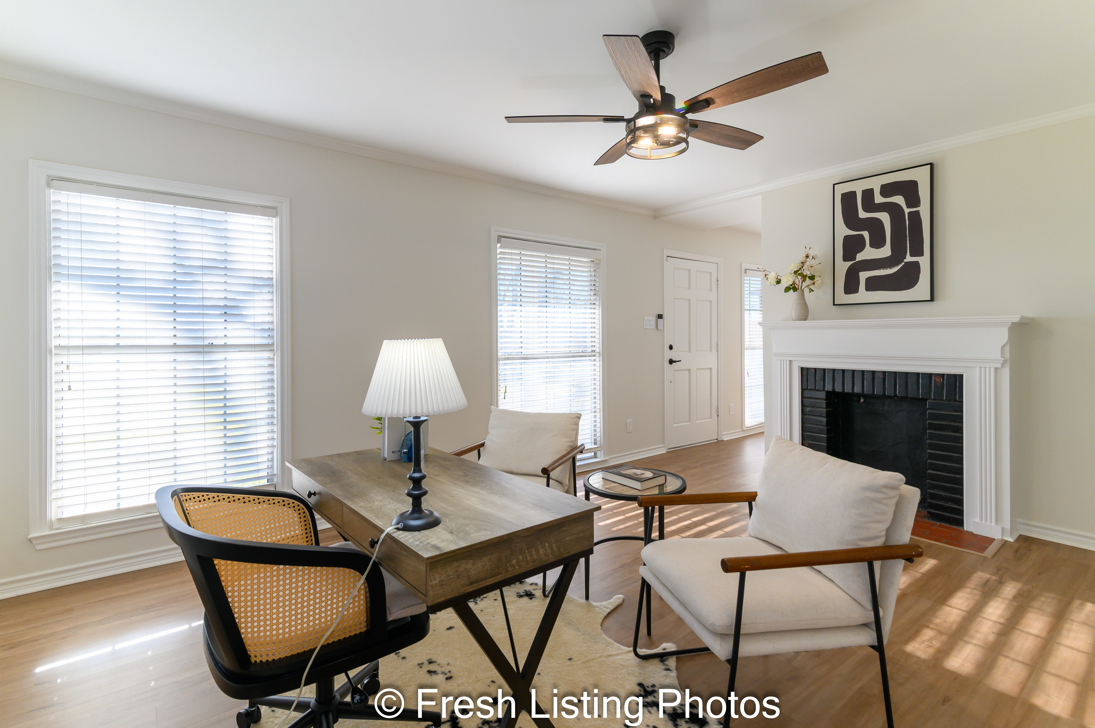 Family room with double sided fireplace and sunny windows