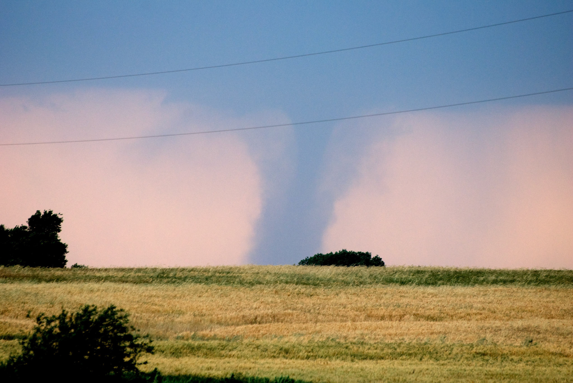 The sun sets behind an EF-3 tornado near Harper, Kansas