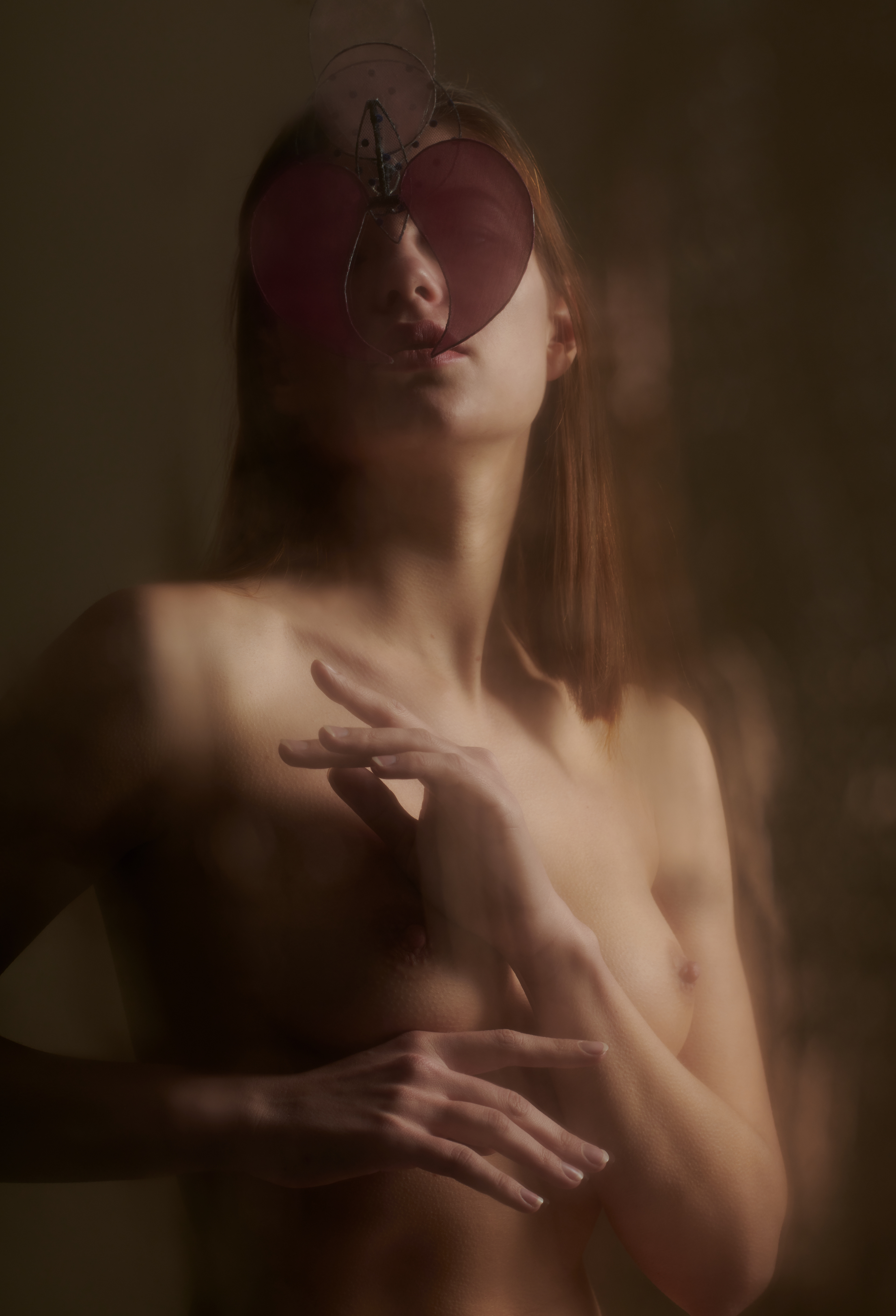 Nude woman portrait wearing a mask shot by David Schweiger in Copenhagen