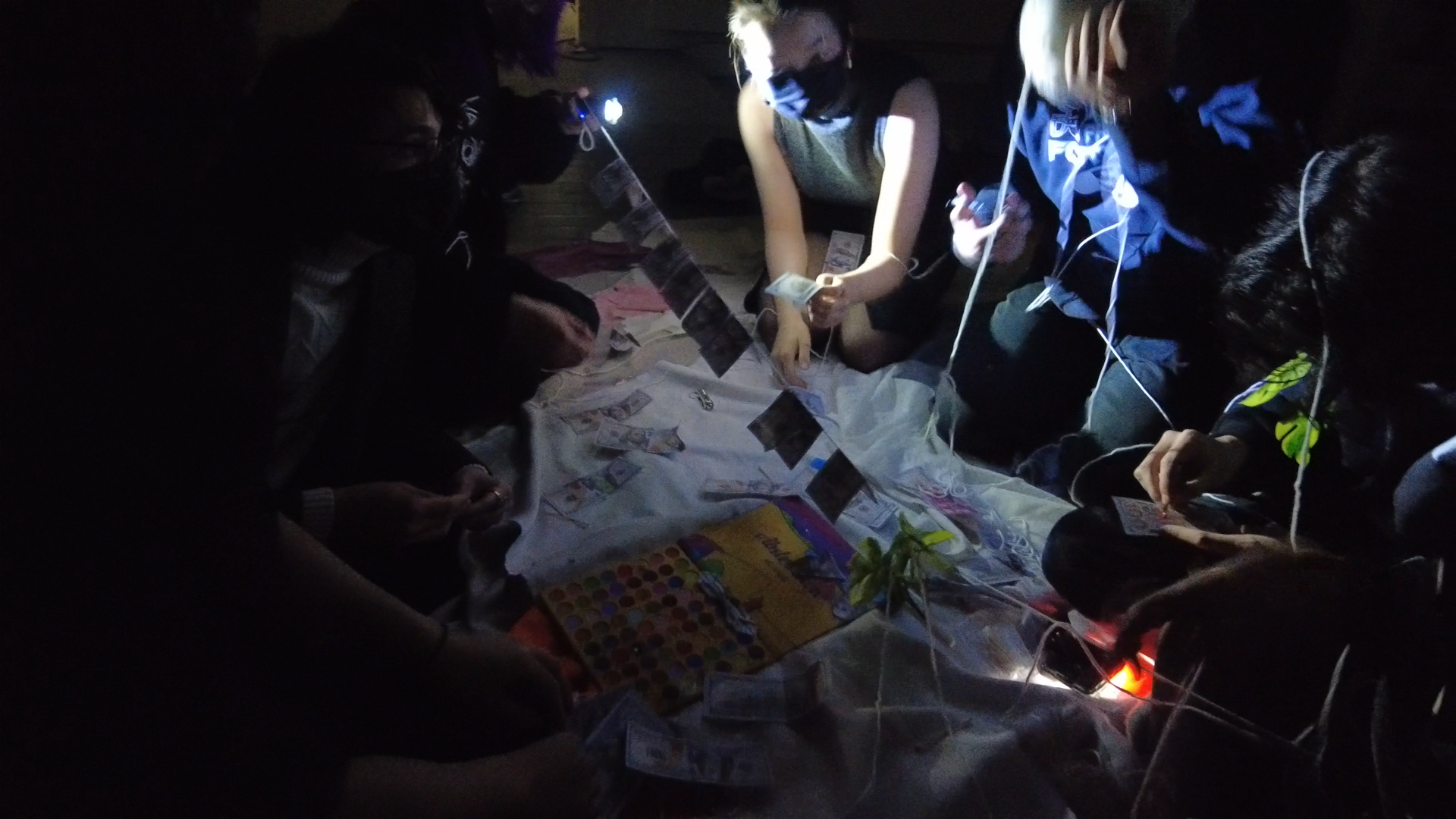participants hanging the painted counterfeit money on a piece of yarn