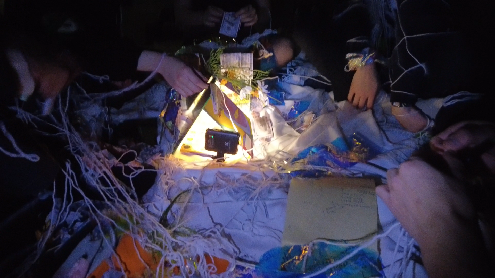 participants making a glowing little house (?)