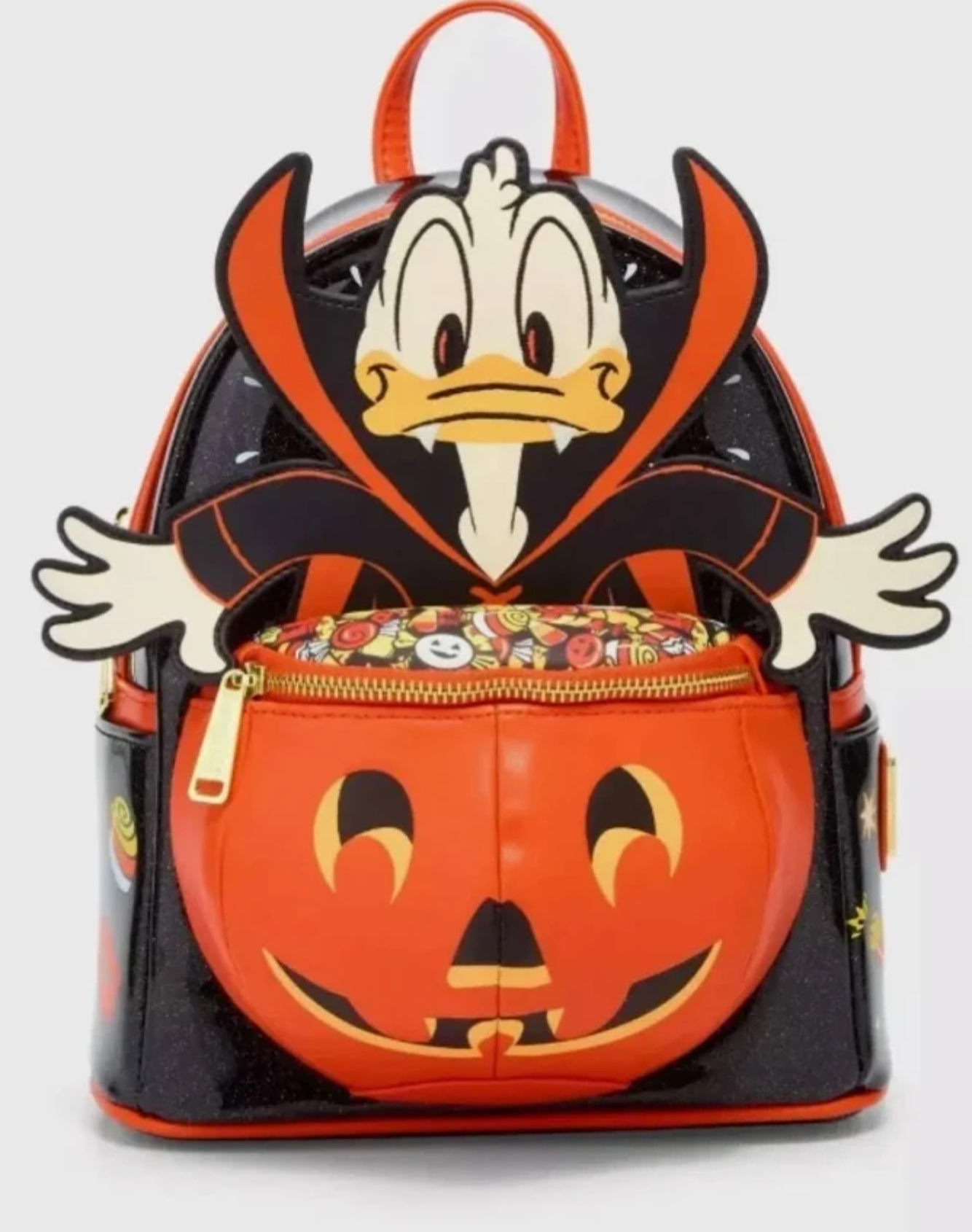 Front: Glitter vinyl body, with printed and embroidered applique. 3D pumpkin pocket with printed candy bowl