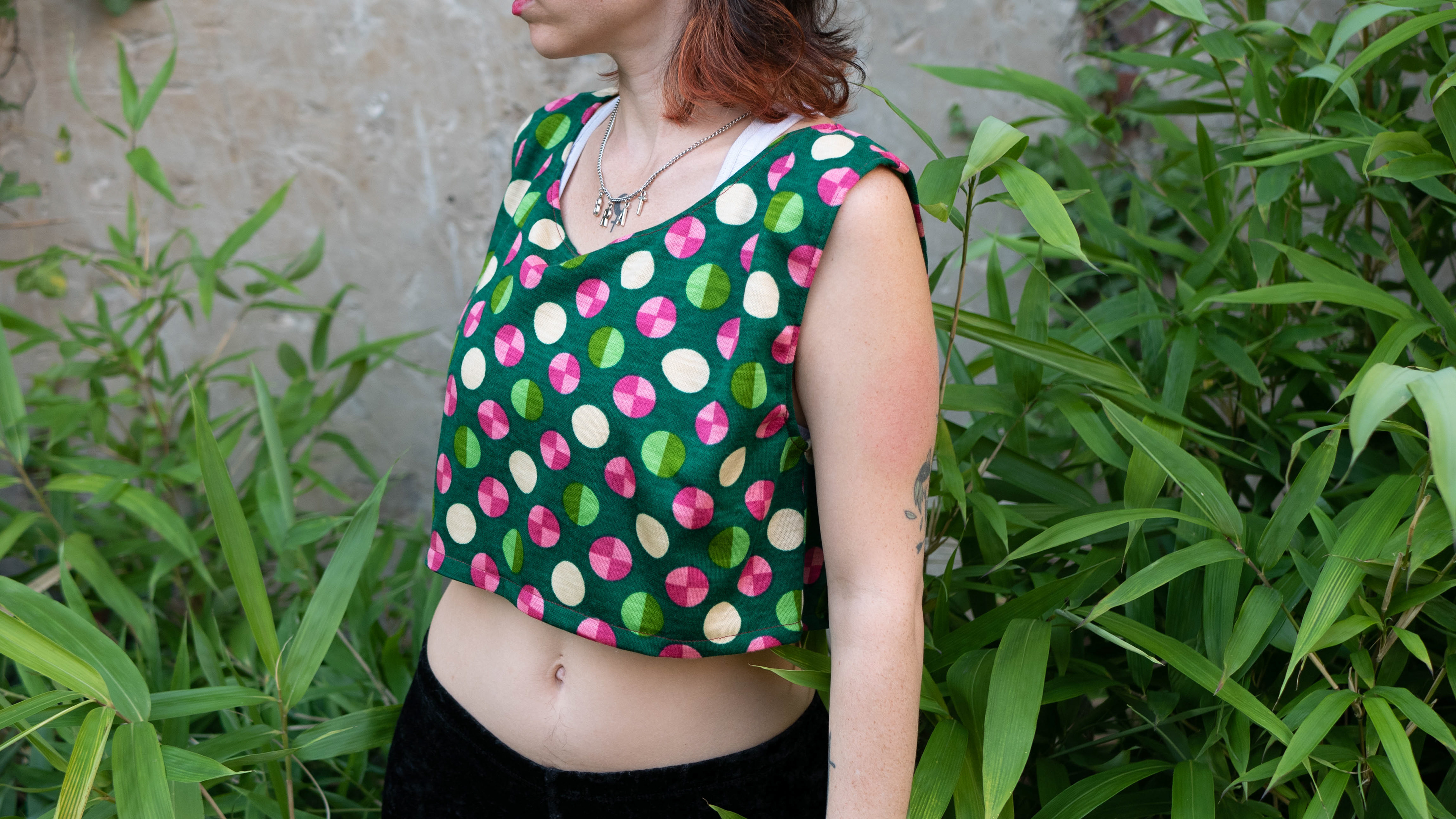 Leo in a green n pink sleeveless crop top