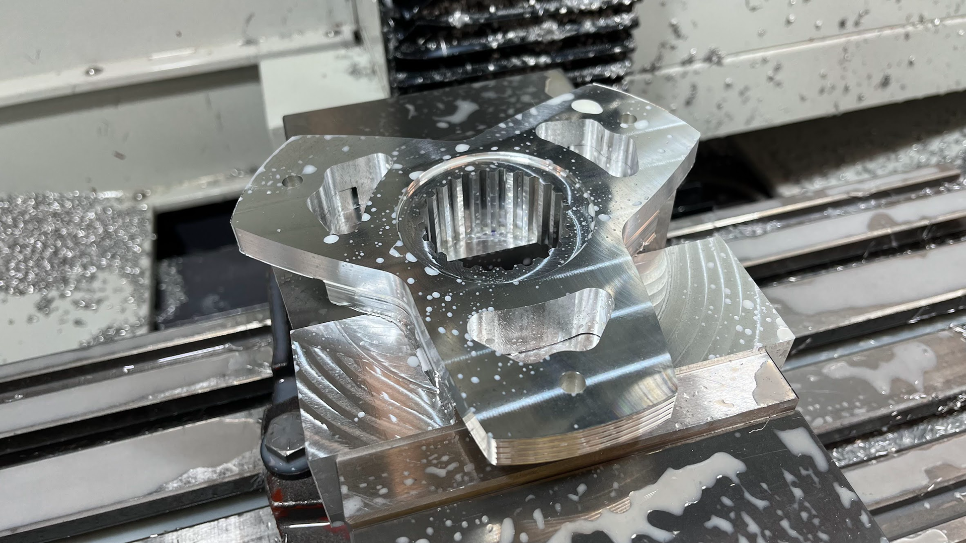 Milling the three clearance holes and lightweighting pockets.