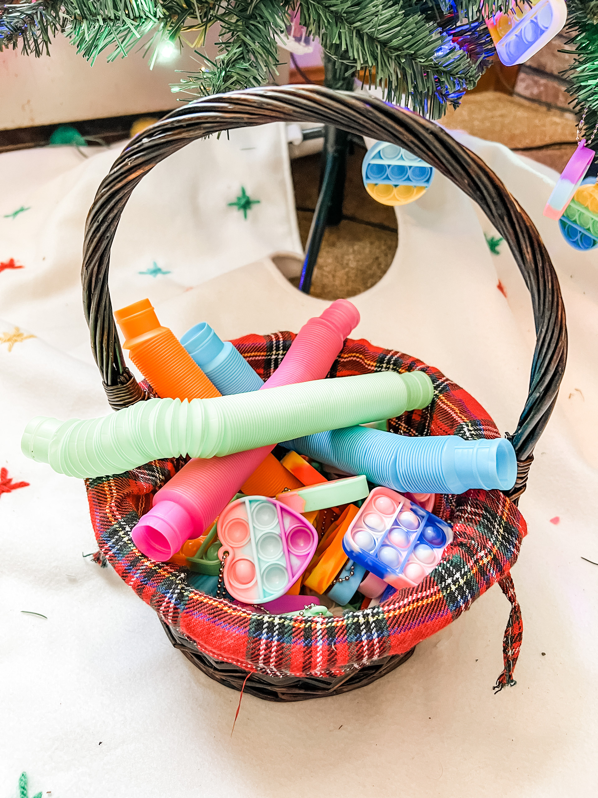 Basket of fidgets for decorating a fidget Christmas tree.