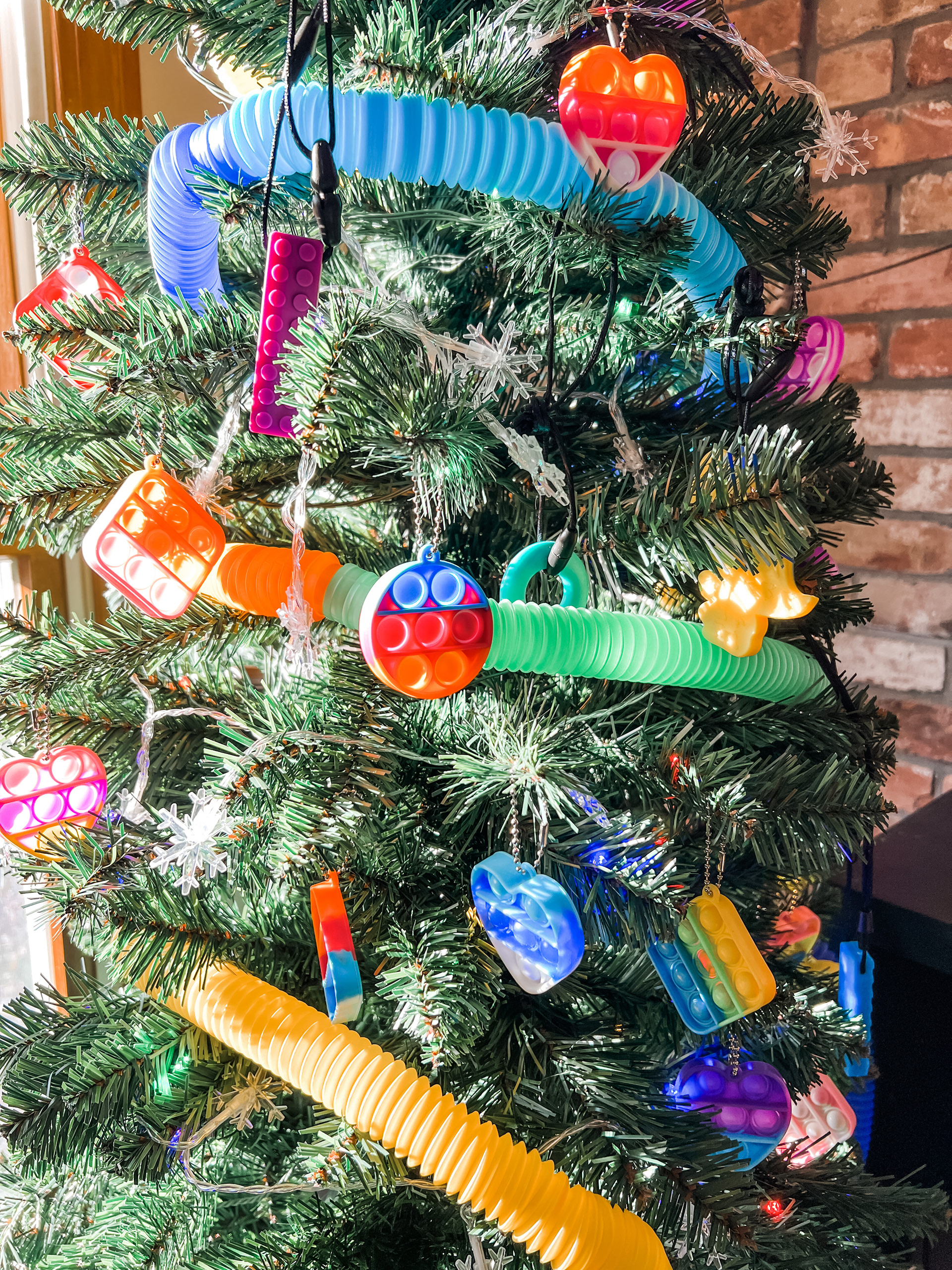 Fidget Christmas tree featuring pop it keychain ornaments and pop tube garland.