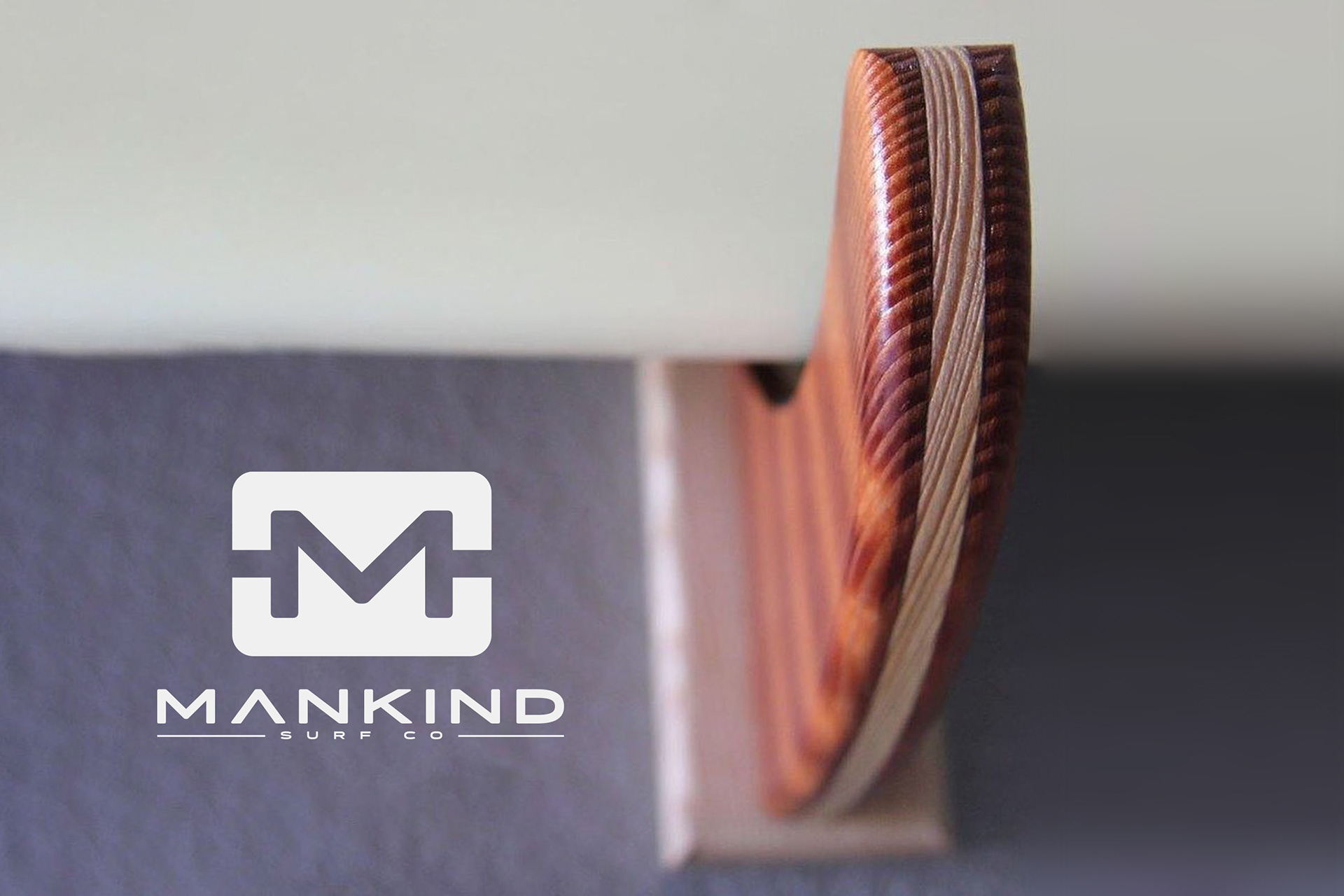 Mankind Surf Co logo with product, wooden surfboard rack