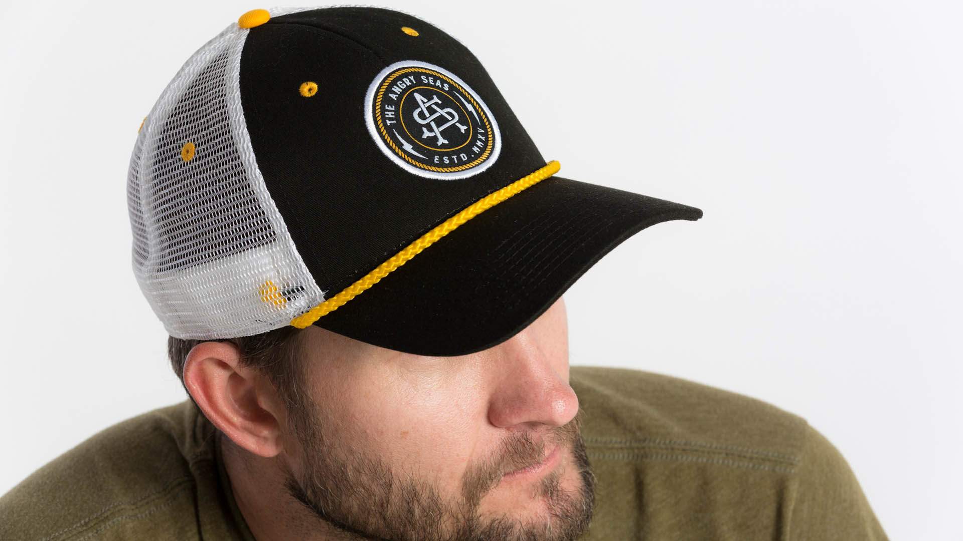 Monogram badge design on embroidered patch trucker hat