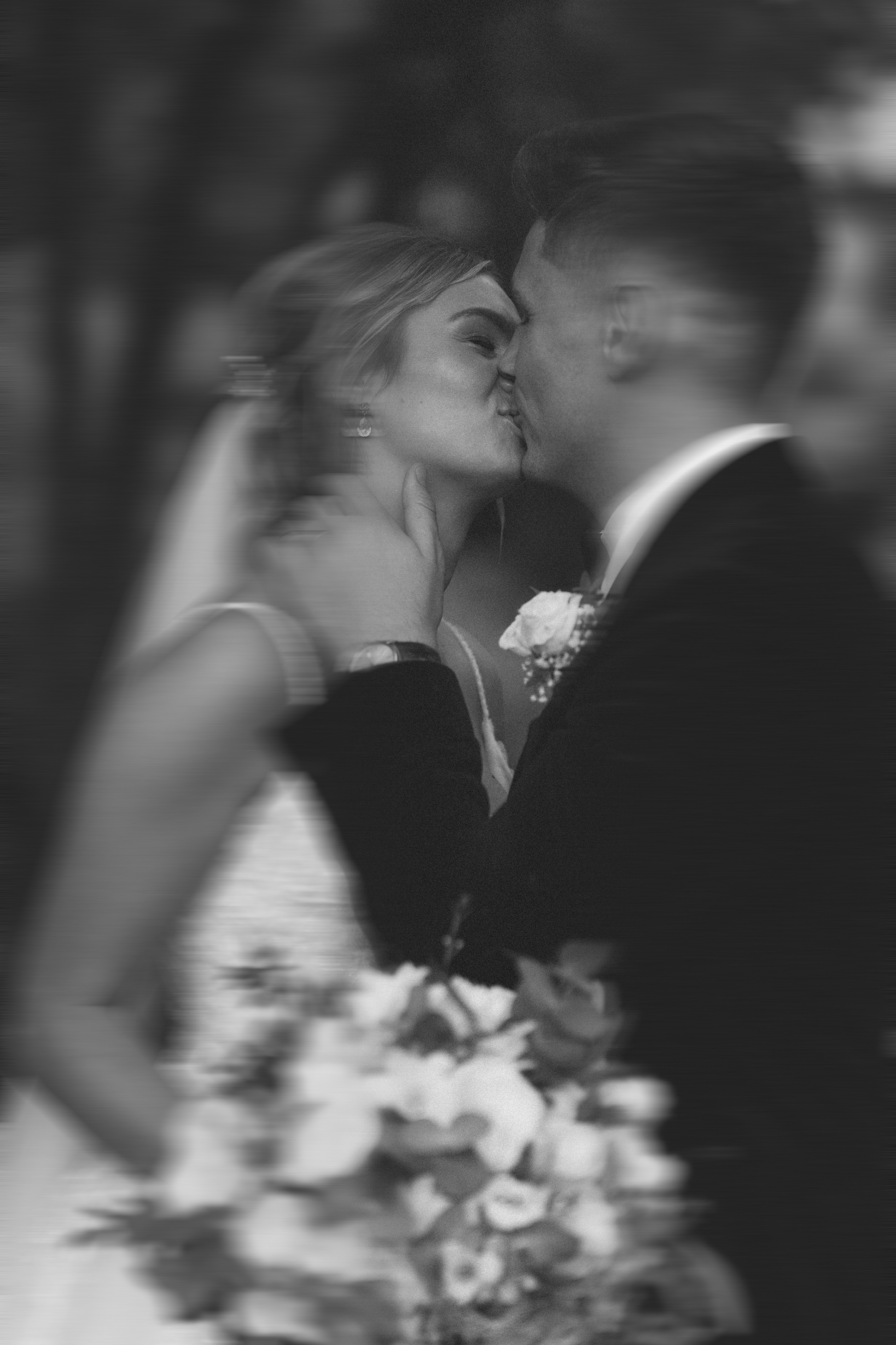 a black and white photo of a married couple at Tyn Dwr Hall after their wedding