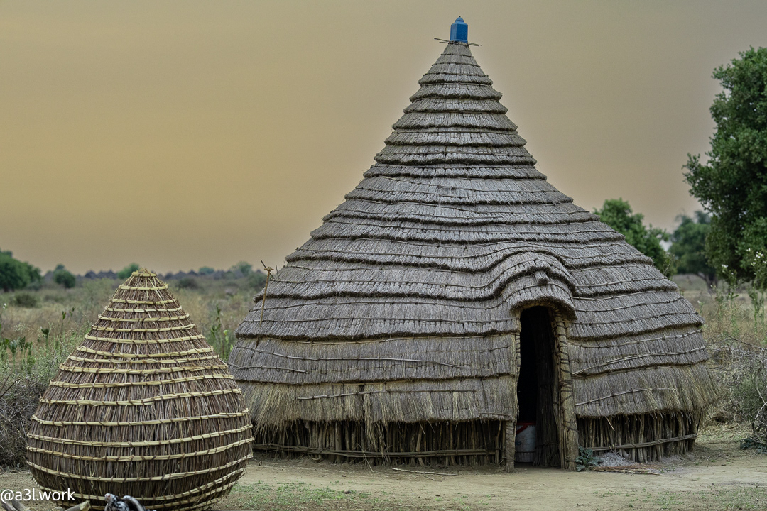 Tukul house made of wooden poles, millet stalks, mud and grass