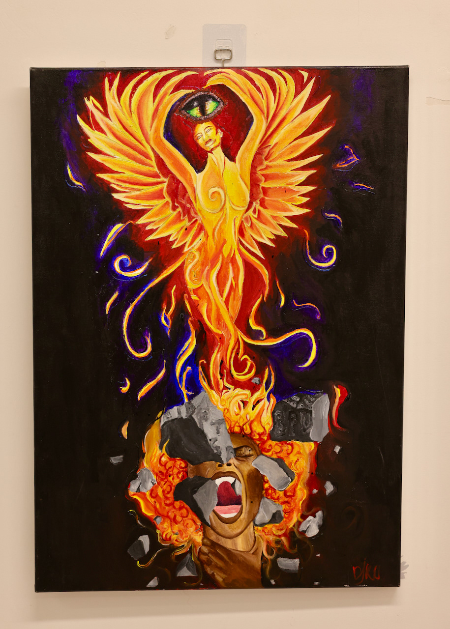 DOOBEE Titel: From the Ashes From the Ashes was Doobe way of expressing frustration when she fell at the mercy of health and trying to work through her struggles and fears. She had a dream that, she was breaking through MH diagnosis and they were on slabs of rock and the all-seeing eye was the eye of a dragon and the phoenix for me and screaming was a way to bring these two ideas together. Acrylic painting, 2021