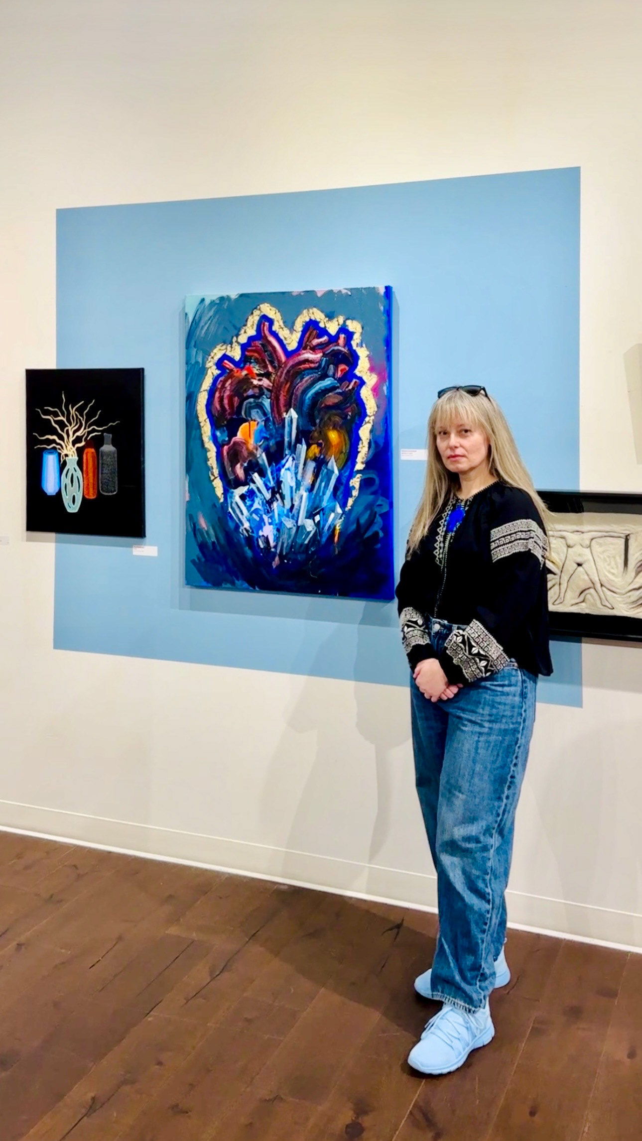 Ukrainian-born Bay Area artist Natasha Kramskaya seen standing in front of her art at Works San Jose