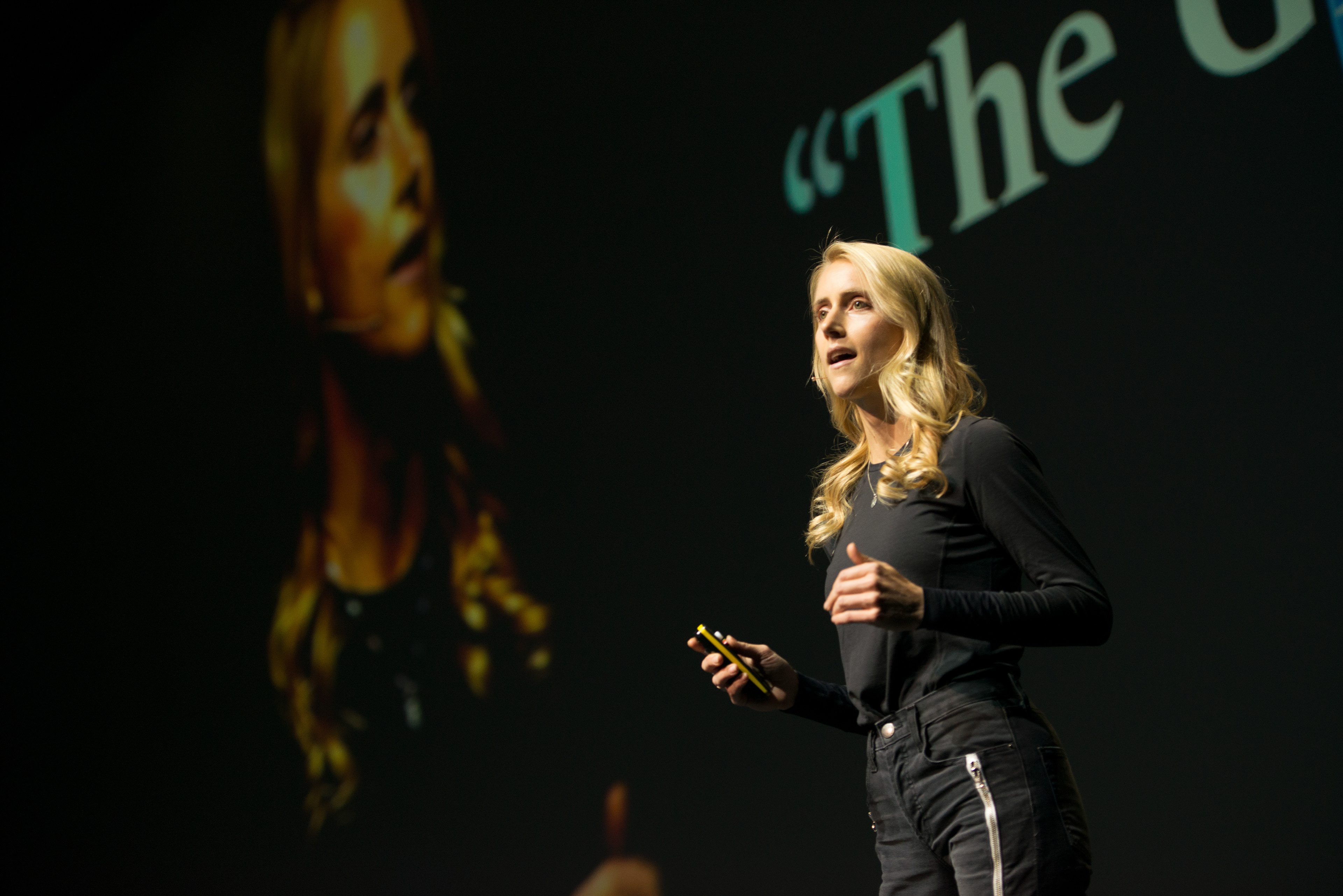 Siri on the big stage holding a talk for over 1000 people