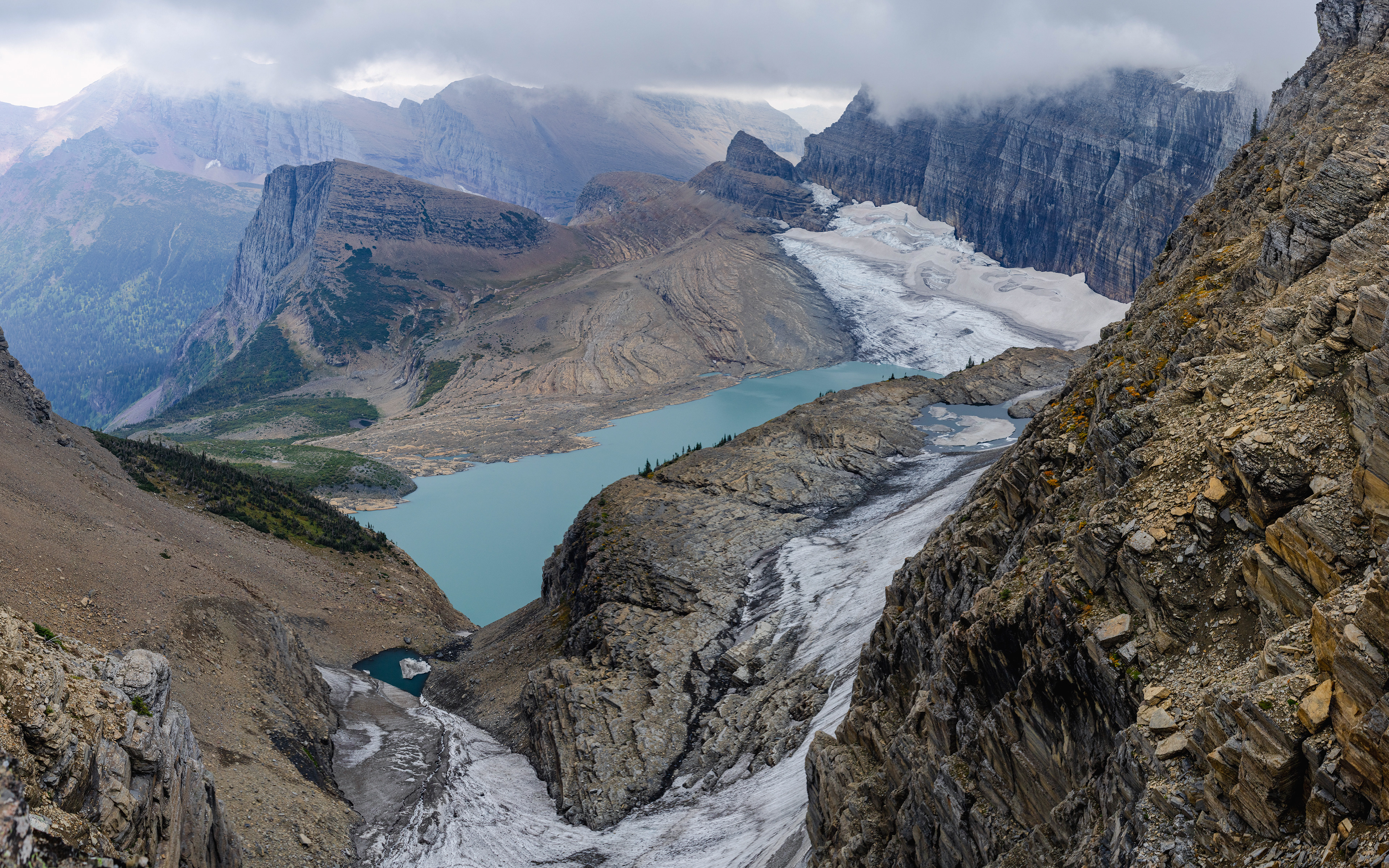 Photograph of Salamander Glacier, Grinnell Glacier, and Grinnell Lake viewed from the Grinnell Lake Overlook in Glacier National Park, Montana, with glacial ice, turquoise water, and surrounding alpine terrain.